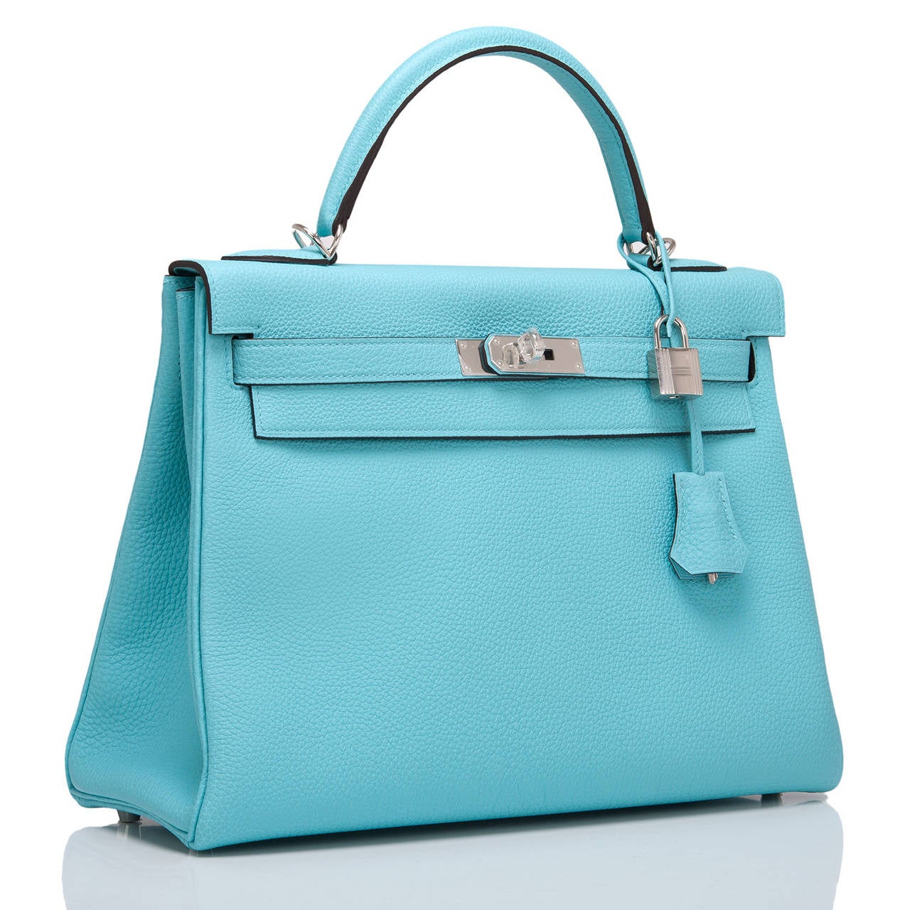 Hermes Blue Atoll Kelly 32cm in rich togo (bull) leather with palladium hardware.

This Kelly features tonal stitching, front toggle closure, a clochette with lock and two keys and a single rolled handle. The interior is lined in Blue Atoll chevre