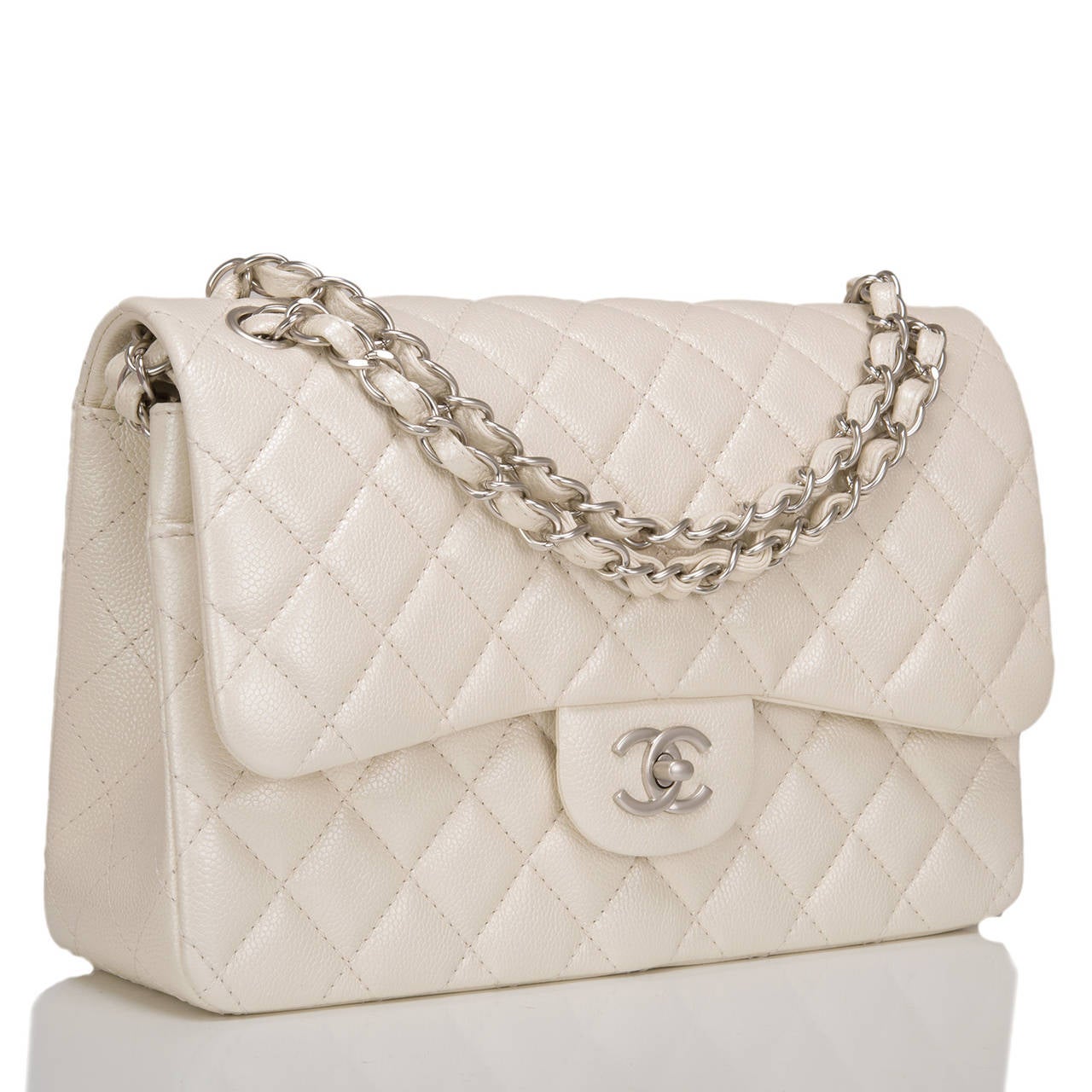Chanel Jumbo Classic in pearlescent ivory caviar leather with matte silver tone hardware; featuring a front flap with signature CC turnlock closure, half moon back pocket, and an adjustable interwoven silver tone chain link and ivory leather