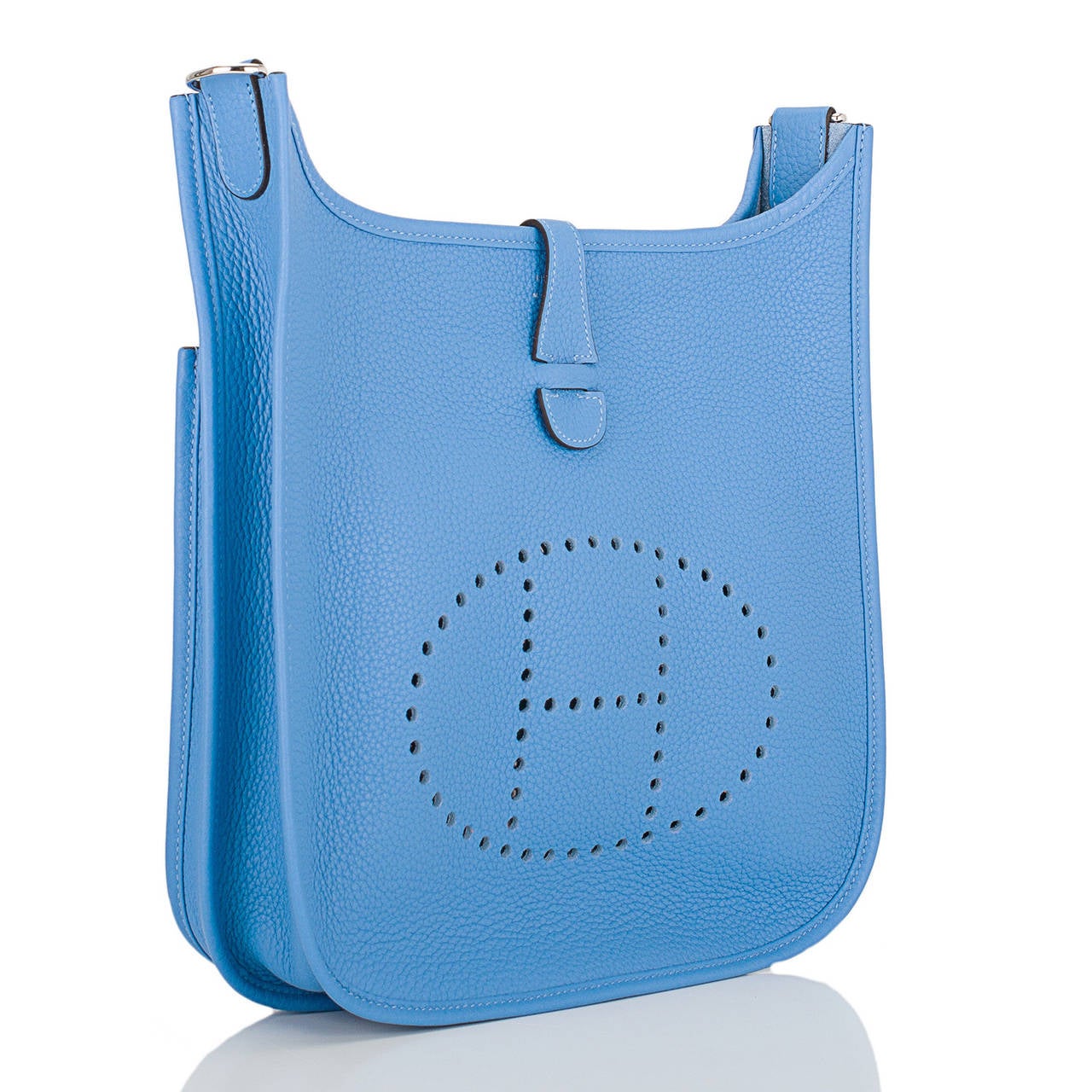Hermes Blue Paradise Evelyne III PM in clemence leather with palladium hardware.

This Evelyne III is made in one of the most in demand colors -- Blue Paradise, a newly introduced color that is a lovely periwinkle blue. This bag is made in