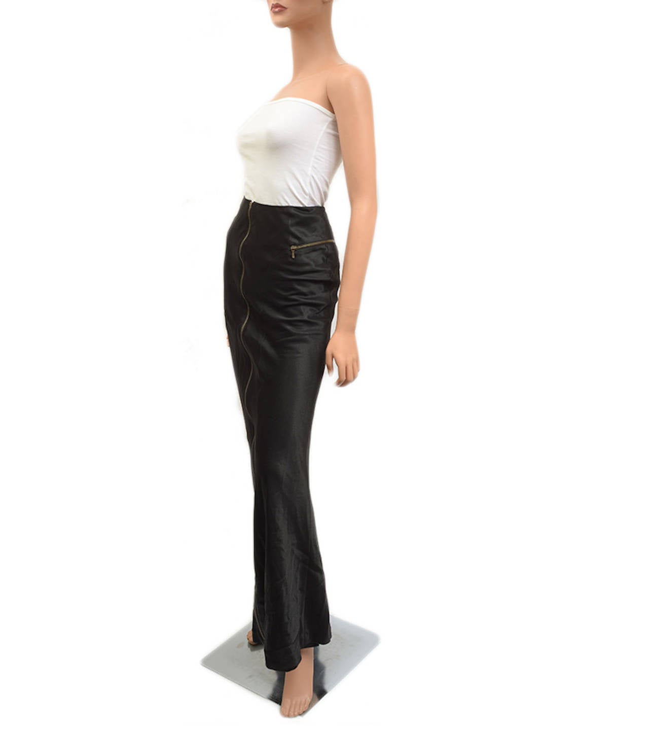 Christian Dior black long black evening skirt with dark gold zipper accents down front and at hips, princess seam details and some flow at bottom. 
 
Fabric:  68% acetate, 32% viscose; lining: 94% silk, 6% elastane
 
Origin: France
 
Retail: 