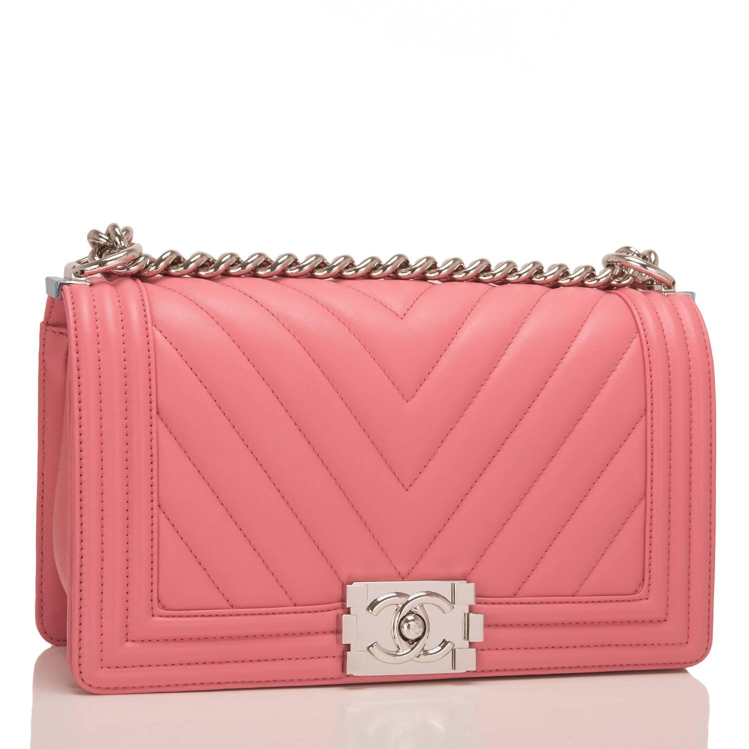 Chanel chevron quilted Medium Boy bag of pink lambskin leather with silver tone hardware.

This bag features a full front flap with the Le Boy CC push lock closure and a silver tone chain link and pink leather padded shoulder/crossbody
