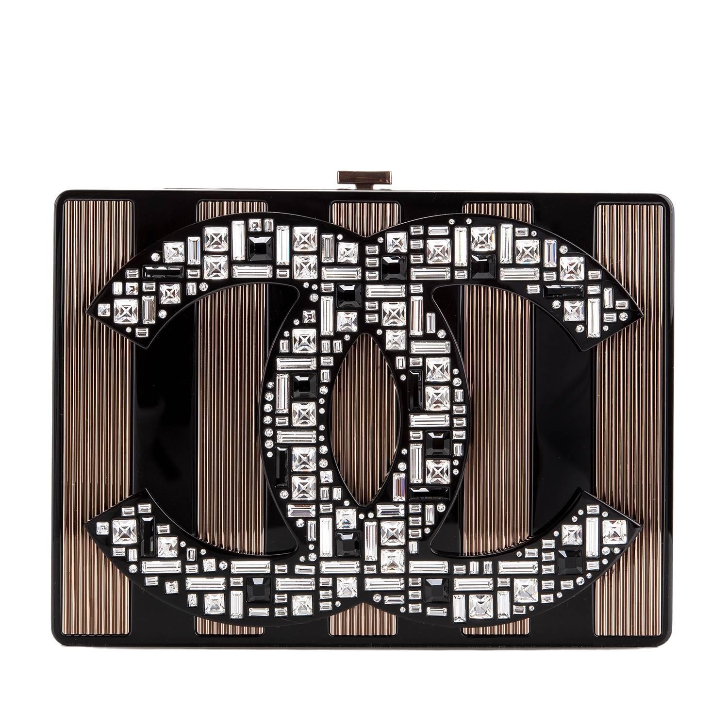 Chanel limited edition, runway "CC" logo minaudiere of black plexiglass with black plexiglass and copper tone hardware.

This rare, collectible bag features front black plexiglass and copper tone metal alternating stripes with the