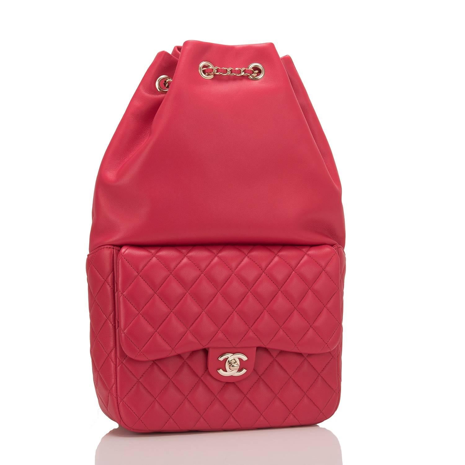 Chanel backpack of red lambskin leather with light gold tone hardware.

This bag features a front quilted leather flap pocket with a signature CC turnlock closure, a top cinch closure, and an interwoven light gold tone chain link and red leather