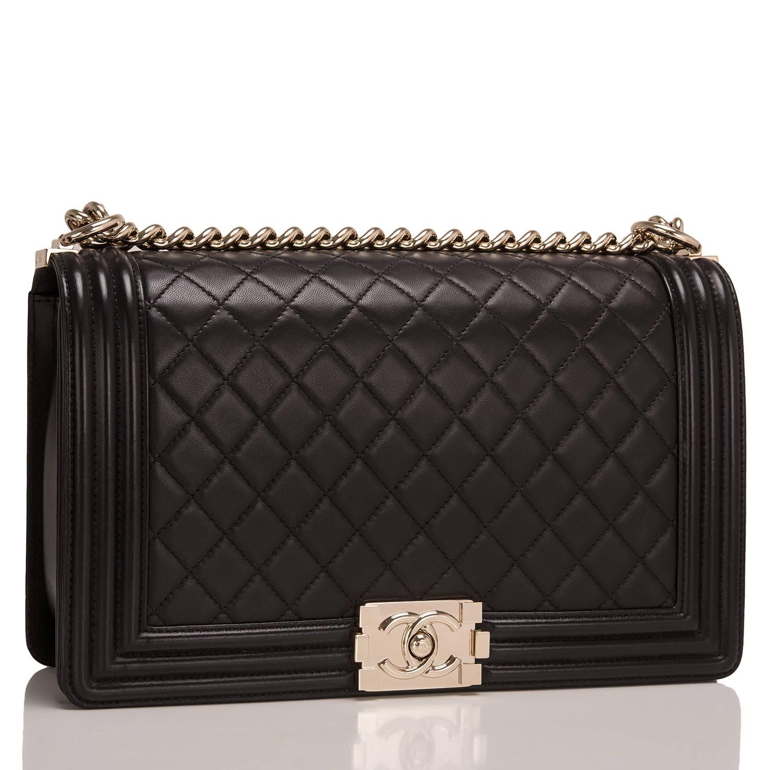 Chanel New Medium Boy bag of black lambskin leather with light gold tone hardware.

This bag features a full front flap with the Le Boy CC push lock closure and a light gold tone chain link and black leather padded shoulder/crossbody strap.

The