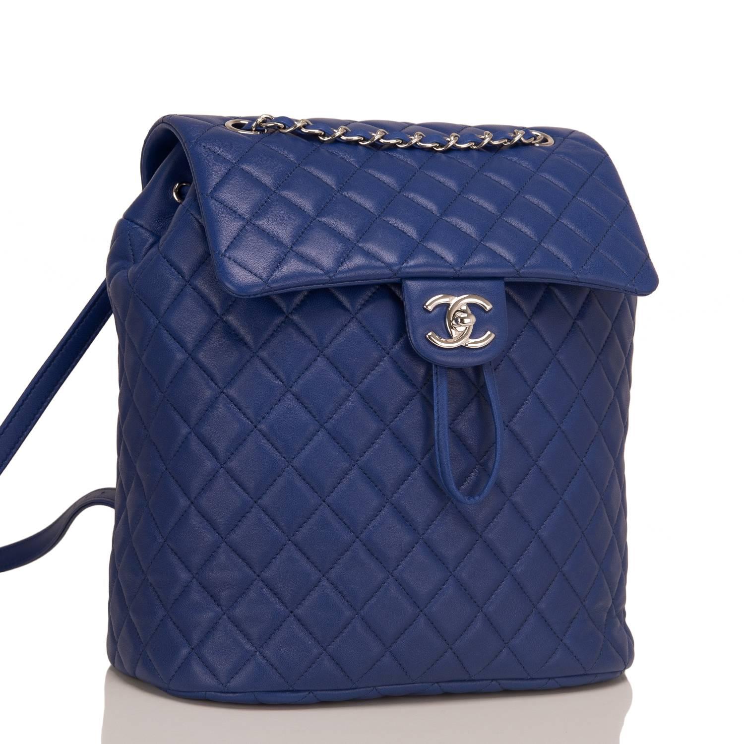 Chanel Urban Spirit large backpack of blue quilted lambskin leather with silver tone hardware.

This bag features a front flap with a signature CC turnlock closure, an open back pocket, and adjustable interwoven silver tone chain link with blue