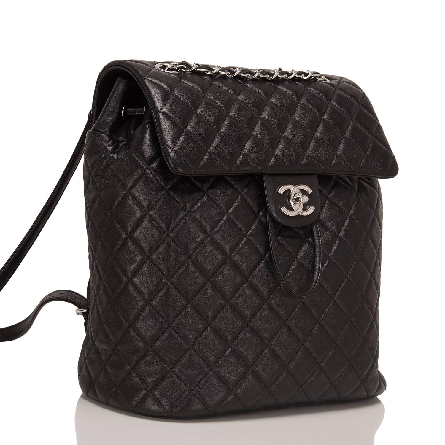 Chanel Urban Spirit large backpack of black quilted lambskin leather with silver tone hardware.

This bag features a front flap with a signature CC turnlock closure, an open back pocket, and adjustable interwoven silver tone chain link with black