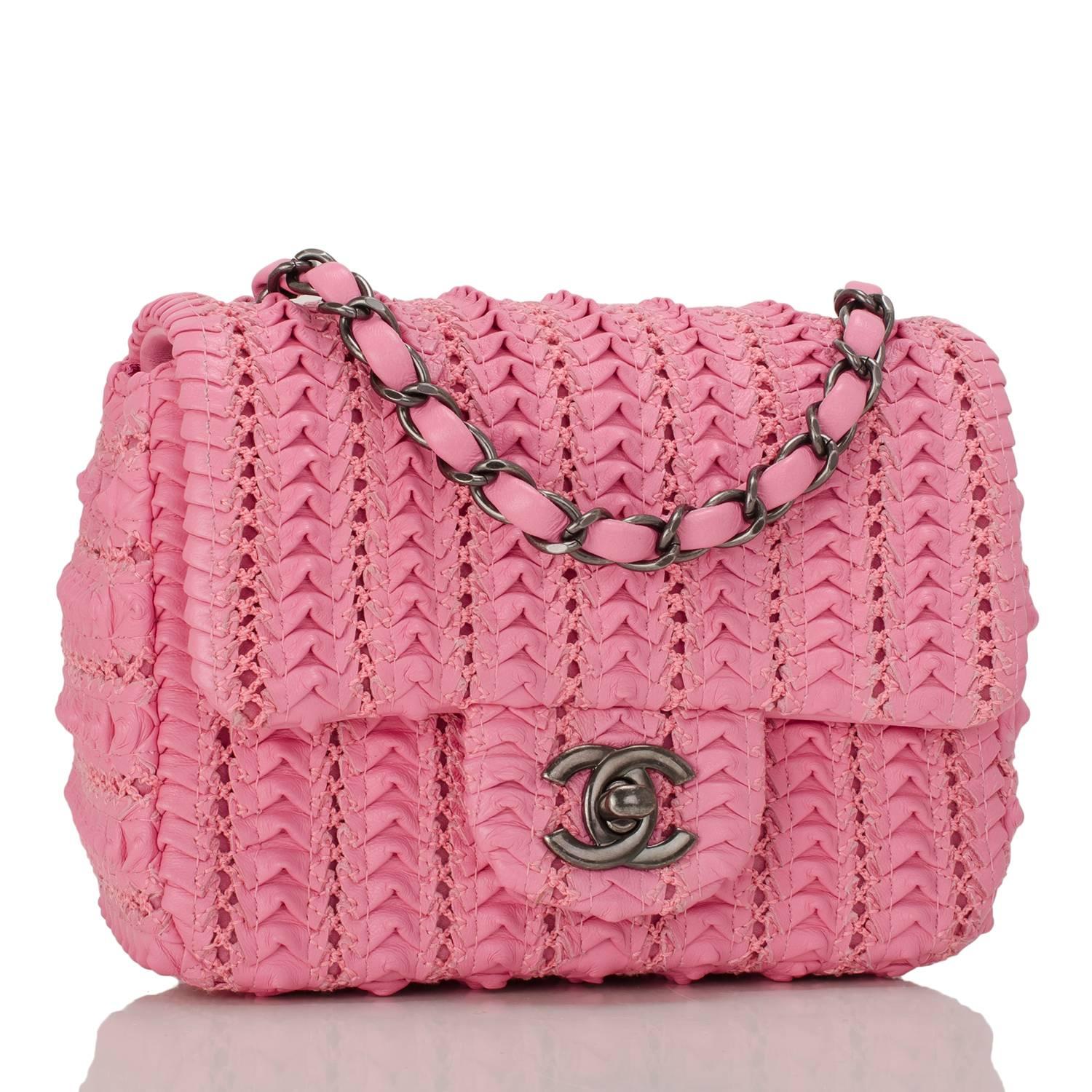 Chanel Square Mini Flap Bag of pink embroidered lambskin leather with ruthenium hardware.

This limited edition runway bag has a front flap with CC turnlock closure and an interwoven ruthenium chain link with pink leather shoulder/crossbody