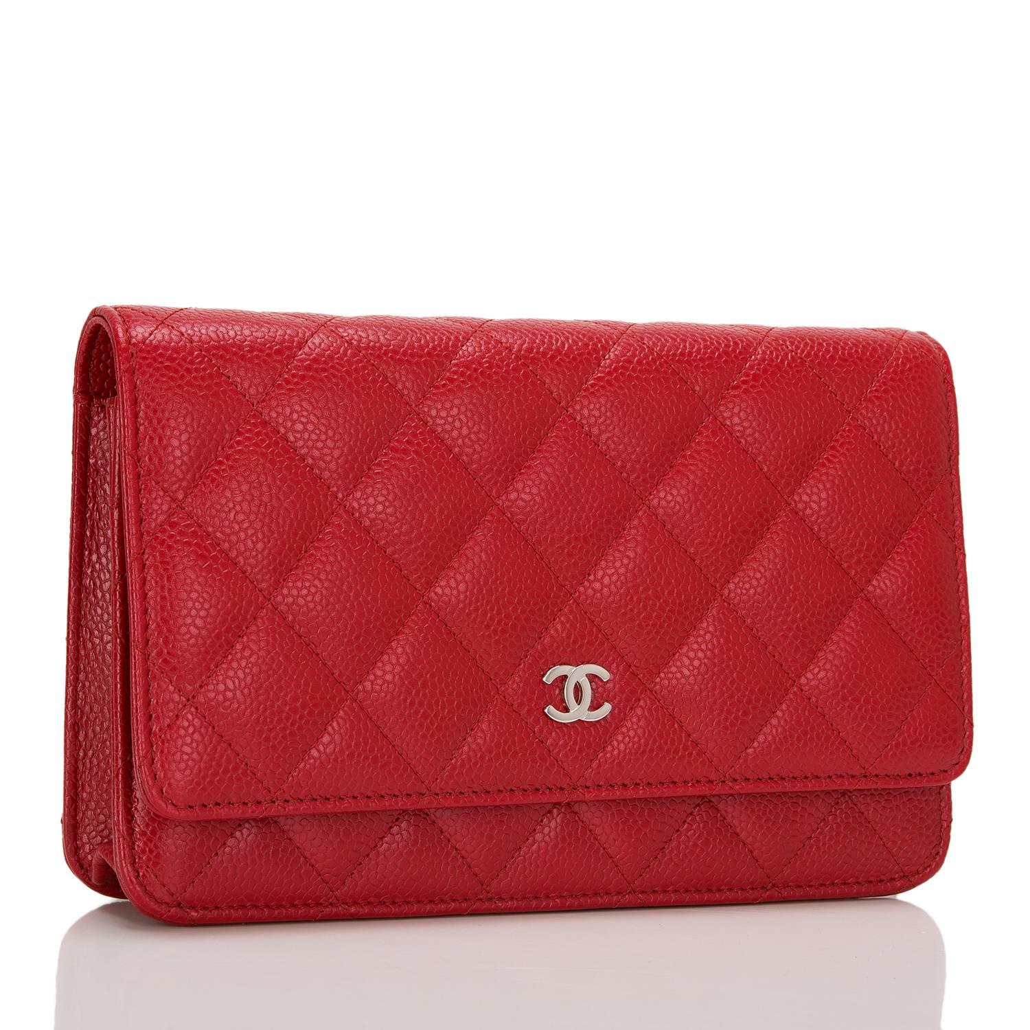 Chanel Classic Wallet On Chain (WOC) of red caviar leather with silver tone hardware.

This Wallet On Chain features signature Chanel quilting, a front flap with CC charm and hidden snap closure, a half moon rear pocket, and an interwoven silver
