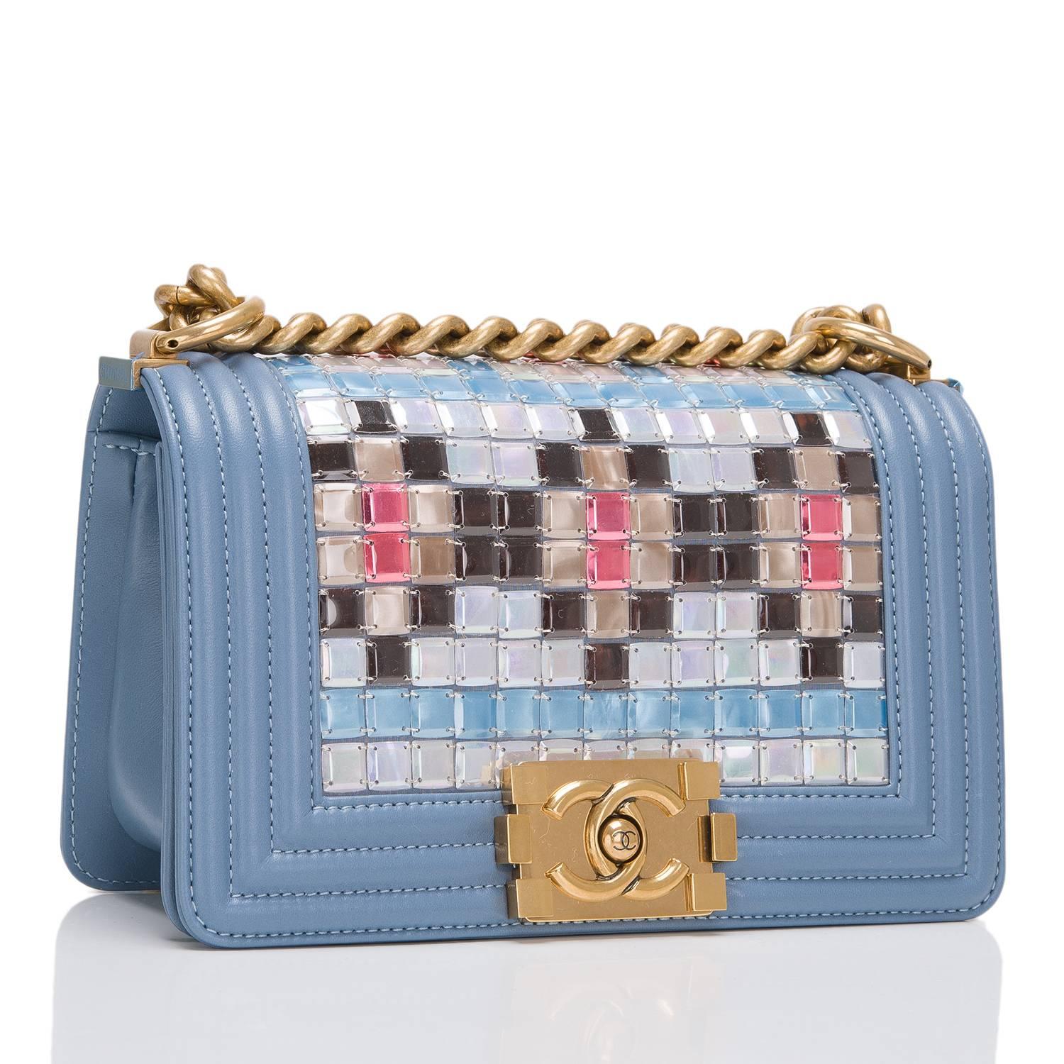 Chanel limited edition Small Boy bag of light blue lambskin leather with antique gold tone hardware.

This bag features a front flap with the Boy signature CC push lock closure, multicolor mosaic embroideries by Lesage, and an antique gold tone