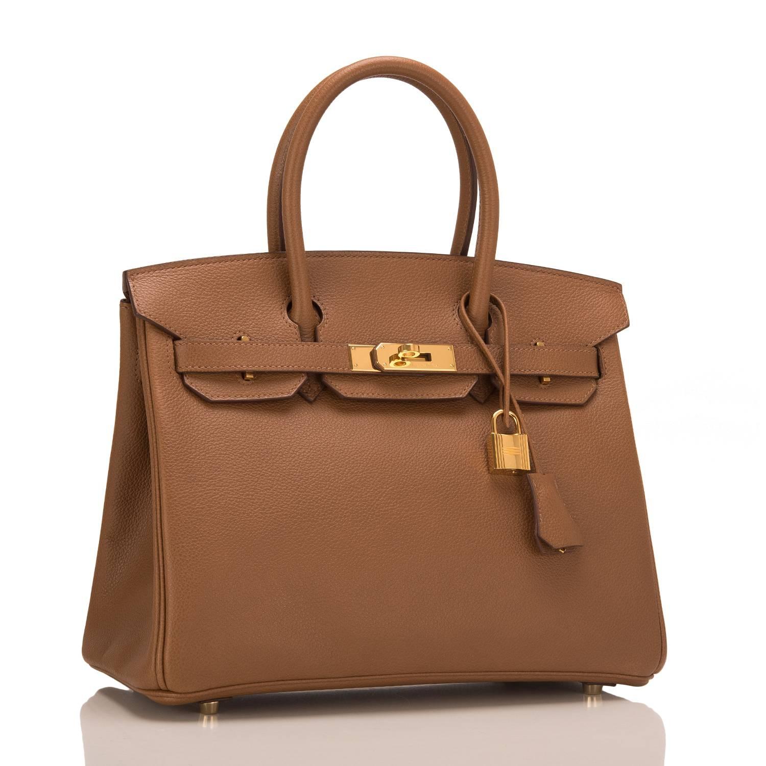 Hermes Alezan Birkin 30cm of Togo leather with gold hardware.

This Birkin has tonal stitching, a front toggle closure, a clochette with lock and two keys, and double rolled handles.

The interior is lined with Alezan chevre and has one zip