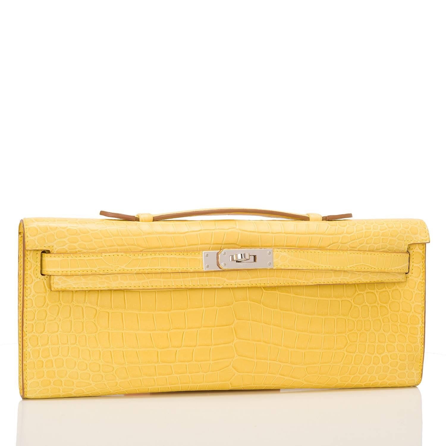 Hermes Kelly Cut of Mimosa matte Porosus Crocodile with palladium hardware.

This exotic Kelly Cut has tonal stitching, front straps with toggle closure and a top flat handle.

The interior is lined in Mimosa chevre leather and features an open