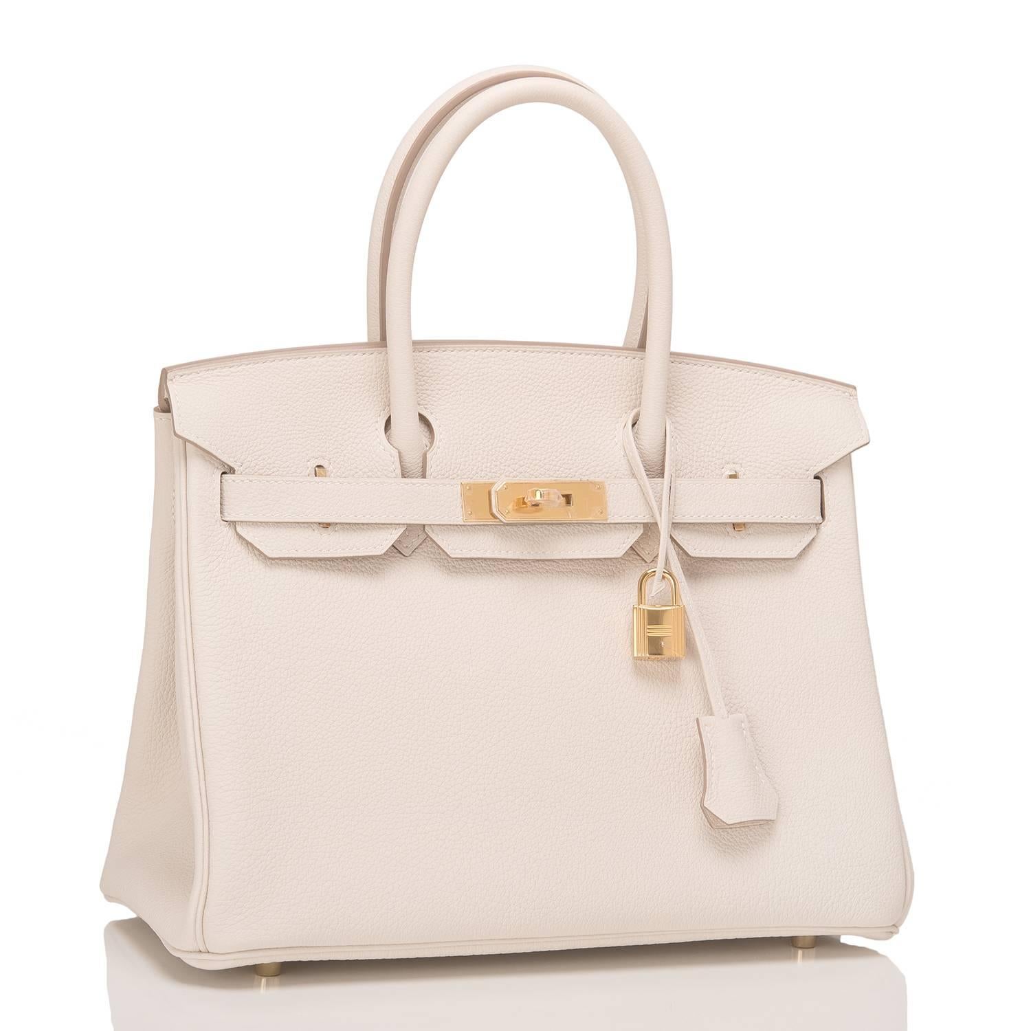Hermes Craie Birkin 30cm of togo leather with gold hardware.

This Birkin features tonal stitching, a front toggle closure, a clochette with lock and two keys, and double rolled handles.

The interior is lined with Craie chevre and has one zip