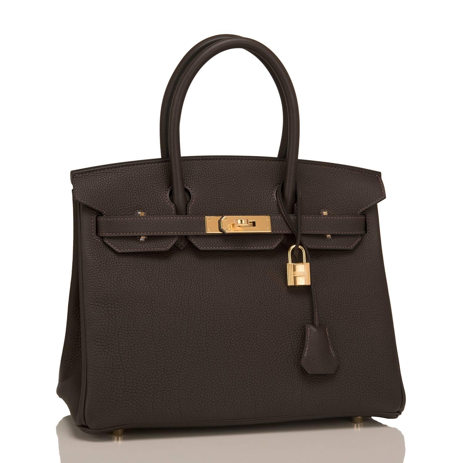 Hermes Macassar Birkin 30cm of Togo leather with gold hardware.

This Birkin has tonal stitching, a front toggle closure, a clochette with lock and two keys, and double rolled handles.

The interior is lined with macassar chevre and has one zip