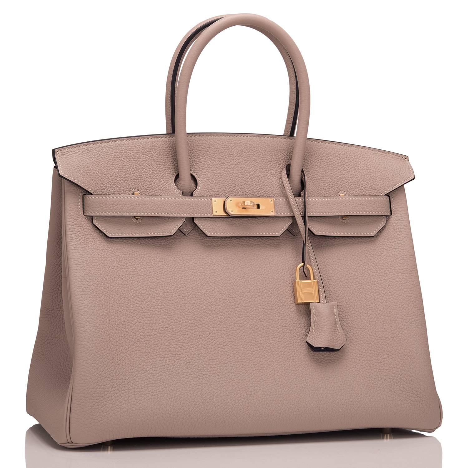 Hermes special order, horseshoe stamped (HSS) bi-color Birkin 35cm of Gris Tourterelle togo leather with Ardroise lining and brushed gold hardware.

This Birkin has tonal stitching, a front toggle closure, a clochette with lock and two keys, and