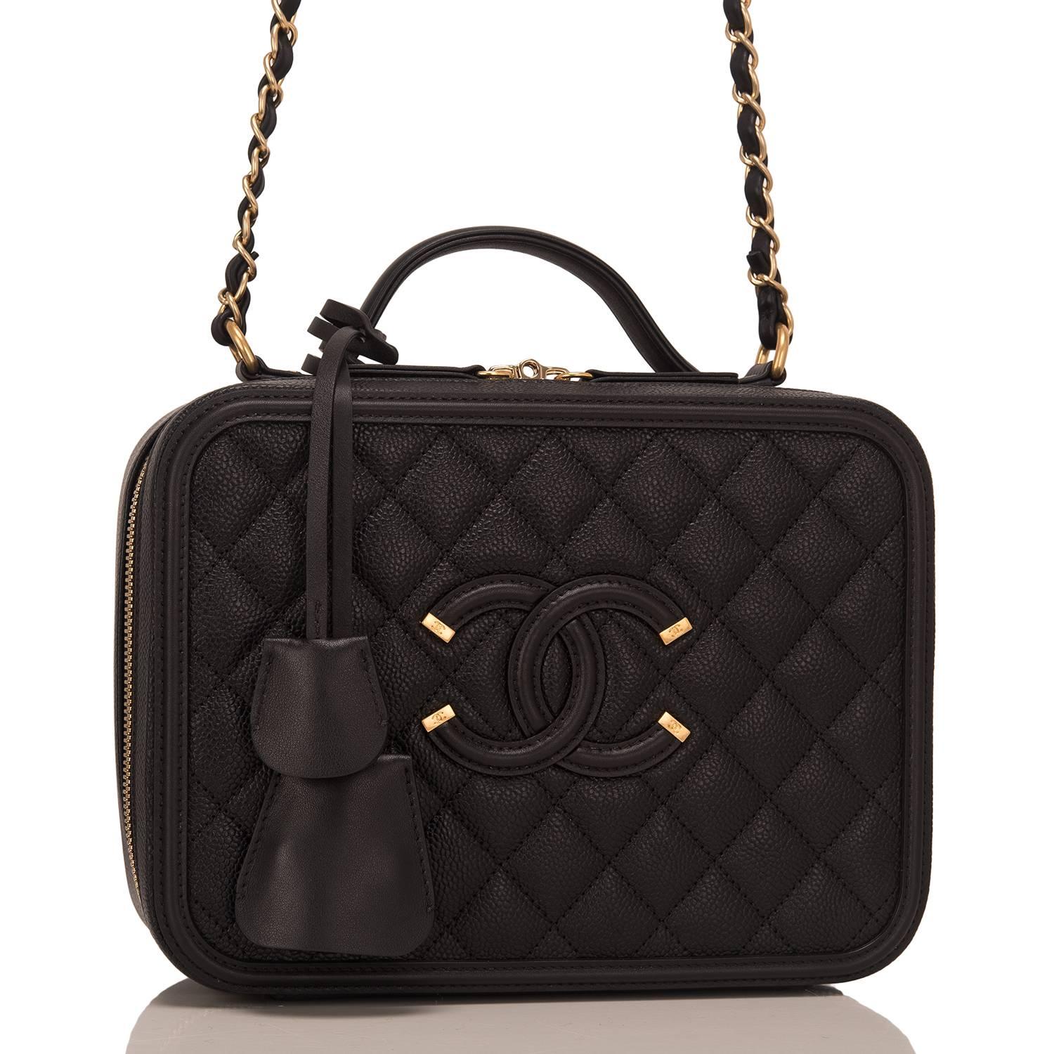 Chanel medium Vanity Case of black caviar leather with gold tone hardware.

This bag features Chanel's signature CC logo sewn on the front, a gold tone CC lock with a clochette, a matching key with another clochette, zip around closure, a leather