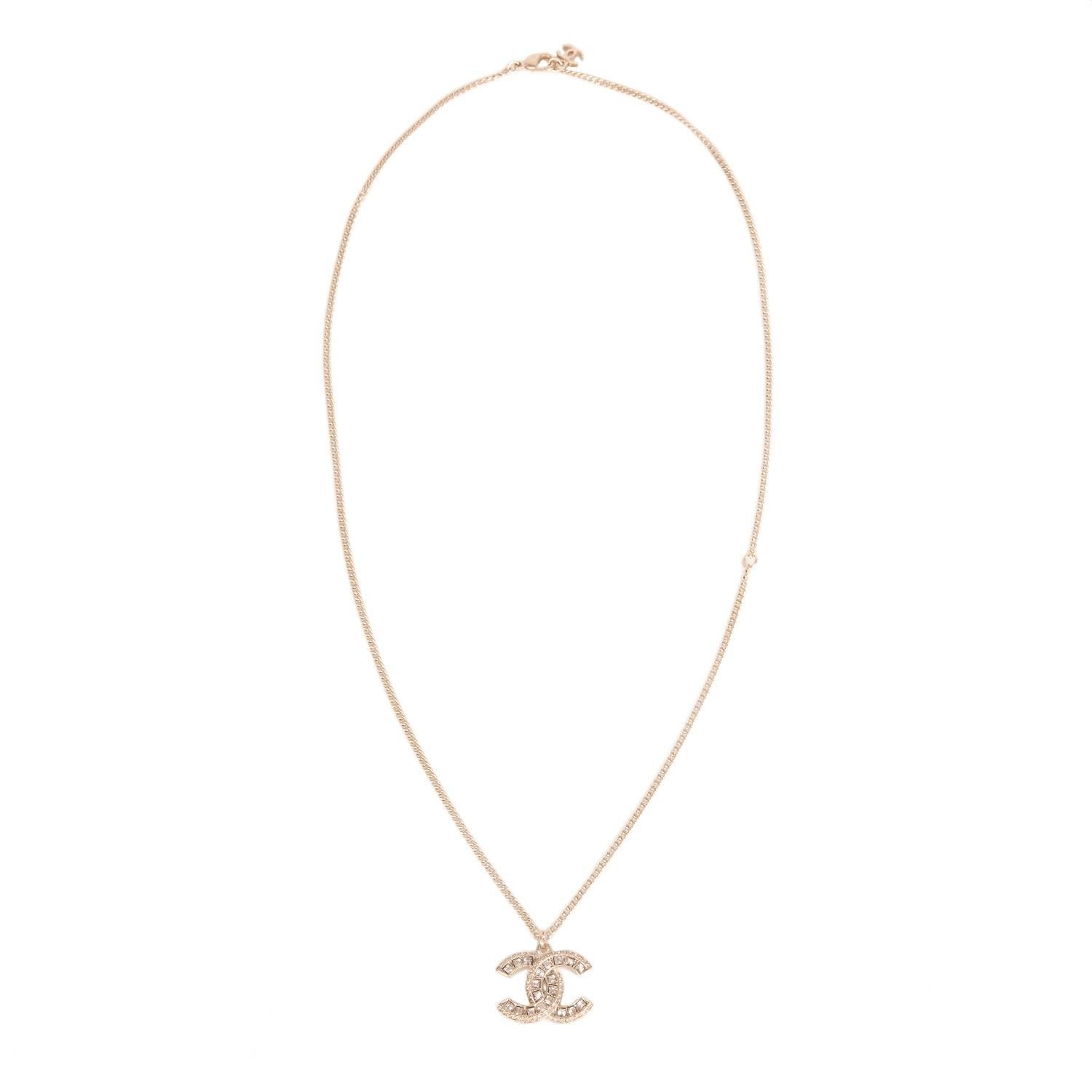 Chanel Swarovski crystal embedded light gold tone logo pendant on a light gold tone chain with a lobster claw closure and dangling CC charm at back.

Collection: 16A

Condition: Pristine; never worn

Accompaned By: Chanel box and
