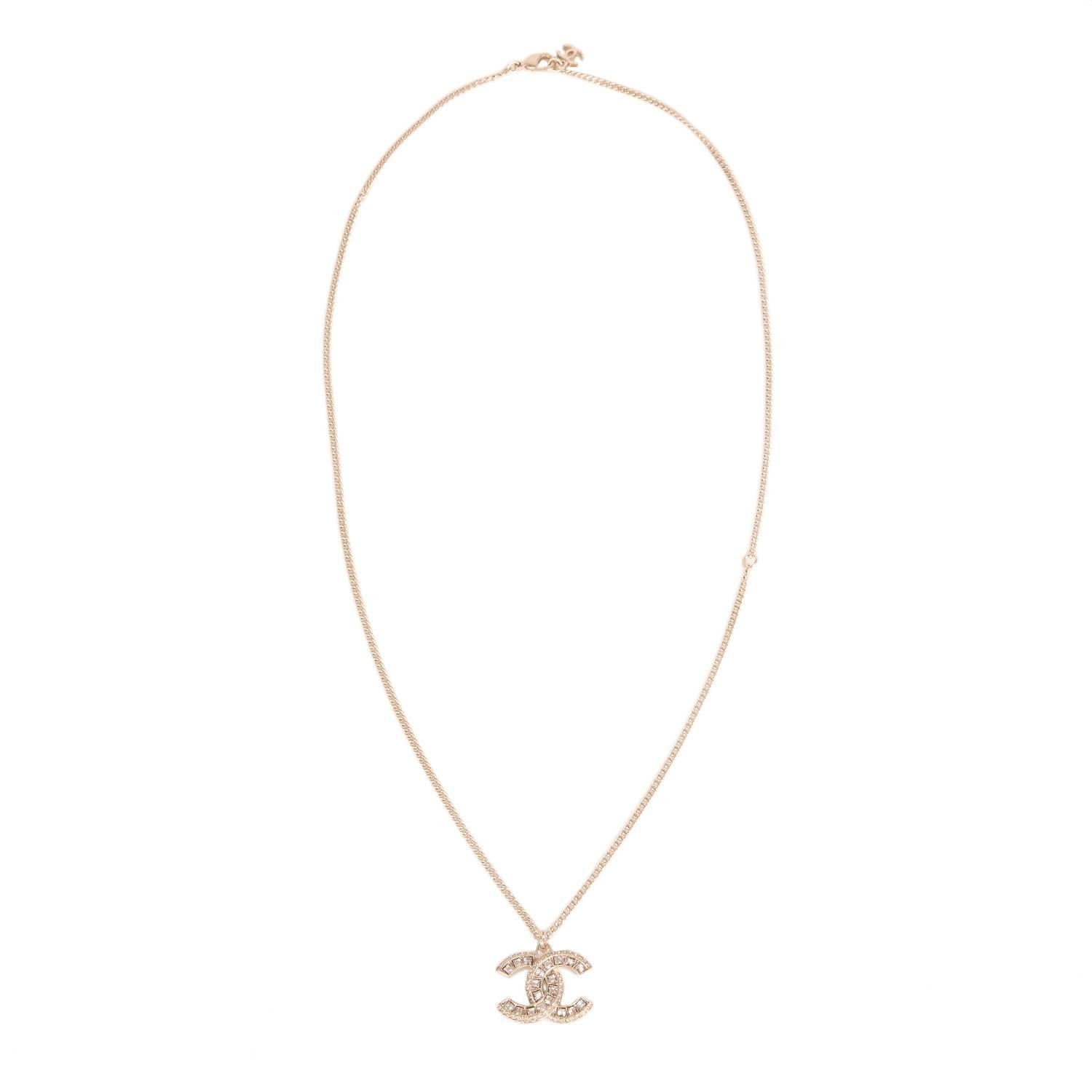 Chanel Swarovski crystal embedded light gold tone logo pendant on a light gold tone chain with a lobster claw closure and dangling CC charm at back.

Collection: 16A

Condition: Pristine; never worn

Accompaned By: Chanel box and