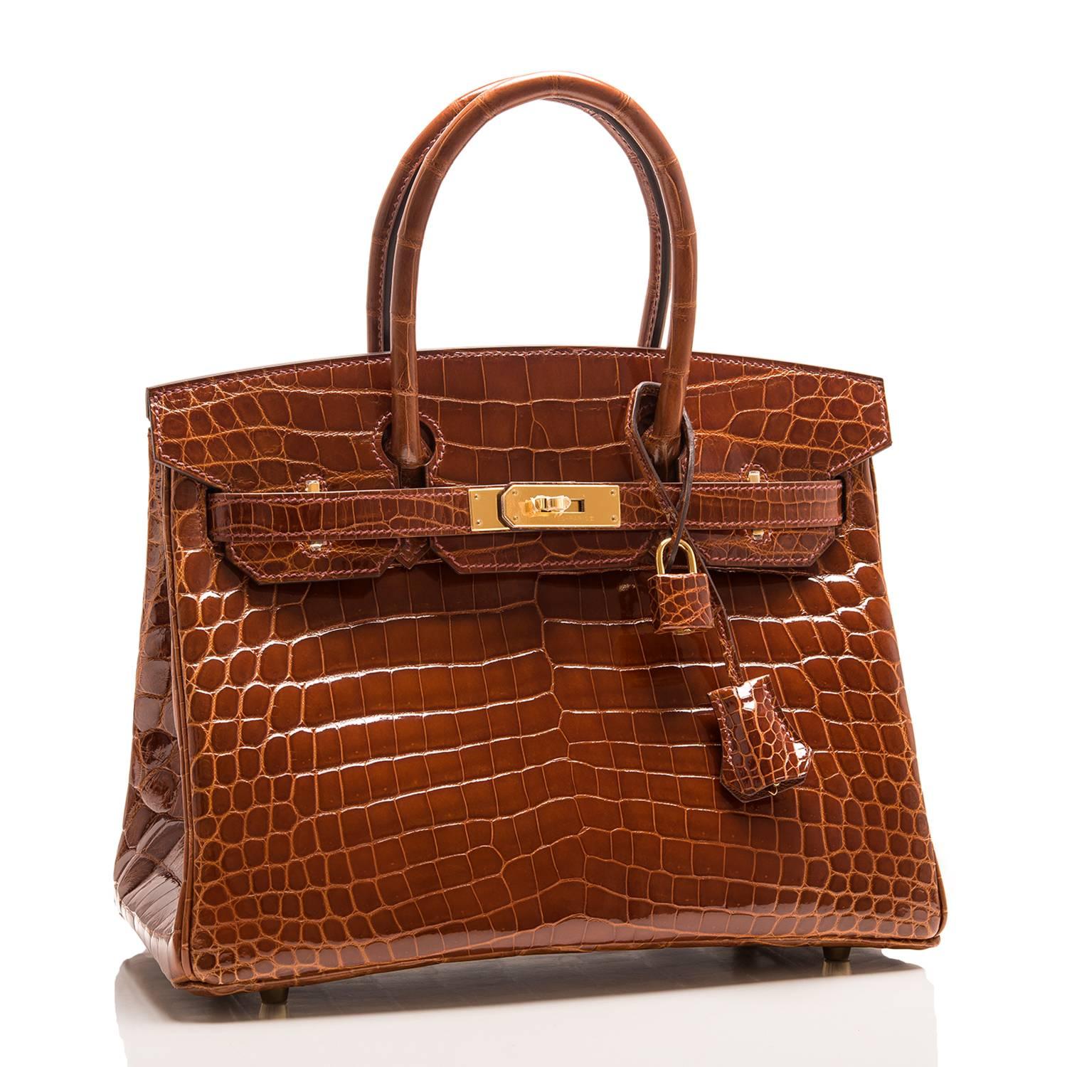 Hermes Miel Birkin 30cm of shiny niloticus crocodile leather with gold hardware.

This Birkin has tonal stitching, a front toggle closure, a clochette with lock and two keys, and double rolled handles.

The interior is lined with Miel chevre and