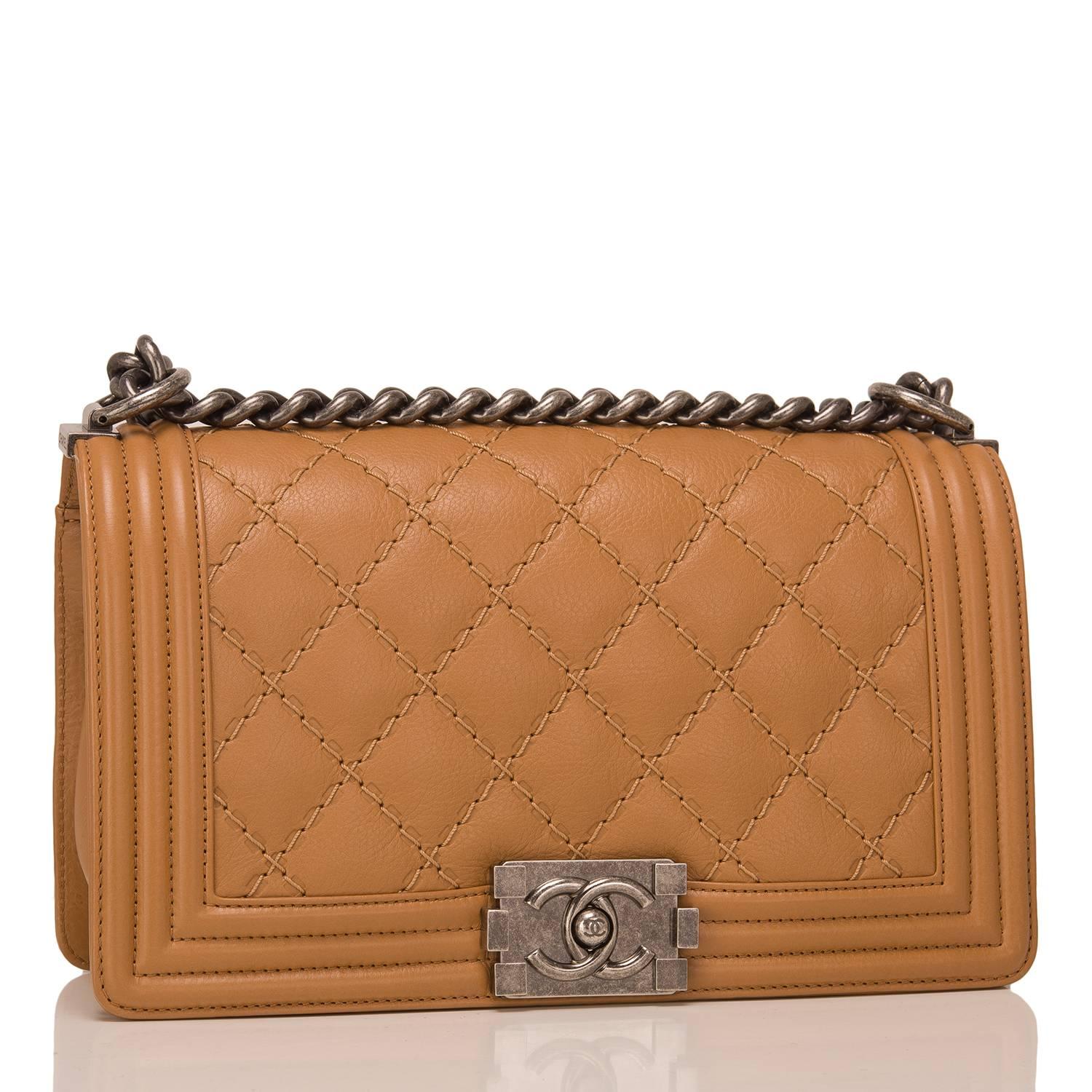 Chanel Old Medium Boy bag of camel quilted calfskin and ruthenium hardware.

This Chanel bag is in the classic Boy style with a full front flap with the Boy signature CC push lock closure detail and ruthenium chain link and camel leather padded