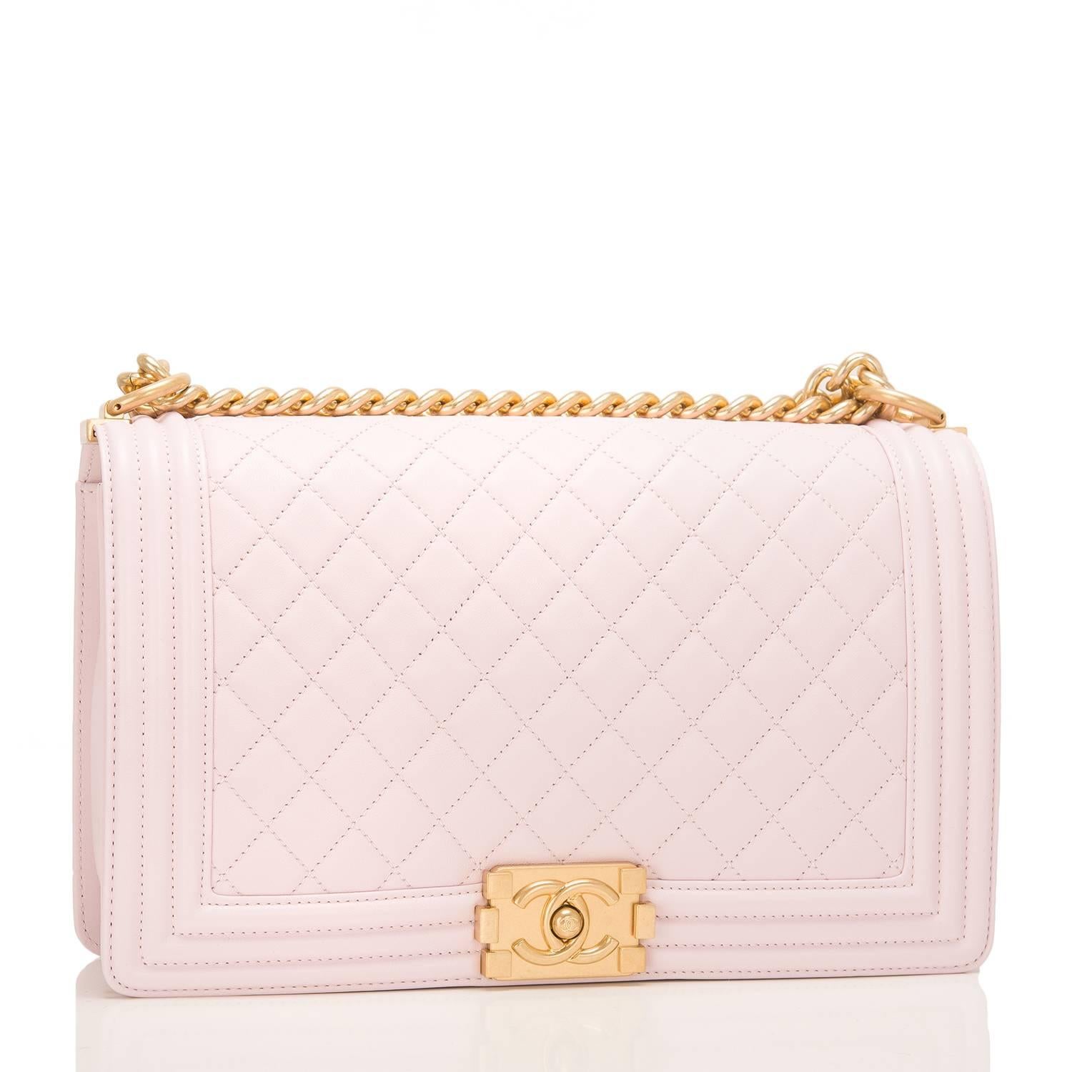 Chanel New Medium Boy bag of pink lambskin leather with antique gold tone hardware.

This bag features a full front flap with the Le Boy CC push lock closure and an antique gold tone chain link and pink leather padded shoulder/crossbody