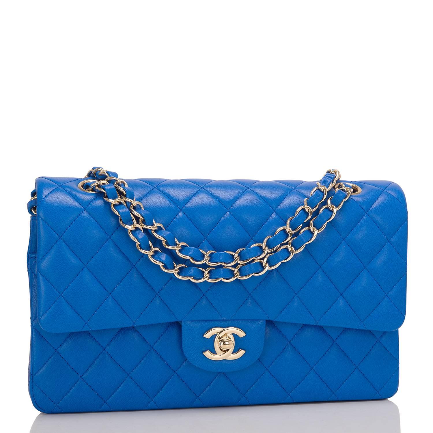 Chanel Medium Classic double flap bag of blue lambskin leather with light gold tone hardware.

This bag features a front flap with signature CC turnlock closure, a half moon back pocket, and an adjustable interwoven light gold tone chain link and