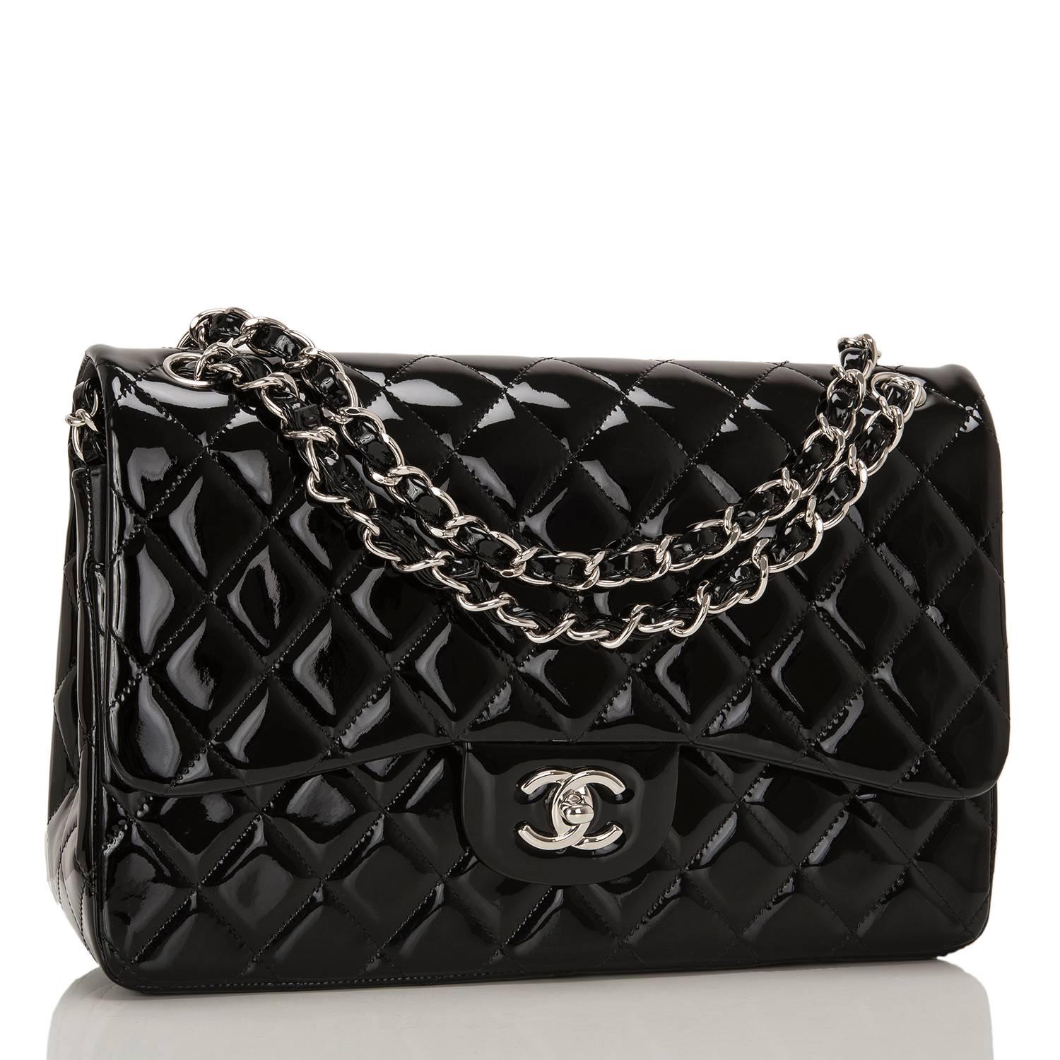 Chanel Jumbo Classic double flap bag of black patent leather with silver tone hardware.

This bag features a front flap with signature CC turnlock closure, a half moon back pocket, and an adjustable interwoven silver tone chain link with black