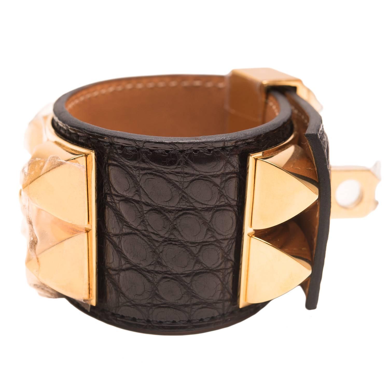 Hermes Collier de Chien (CDC) in Black alligator with gold plated hardware in size small.

This style features gold pyramid studs, center ring and adjustable push lock closure.

Collection: O Square

Origin: France

Condition: Pristine,
