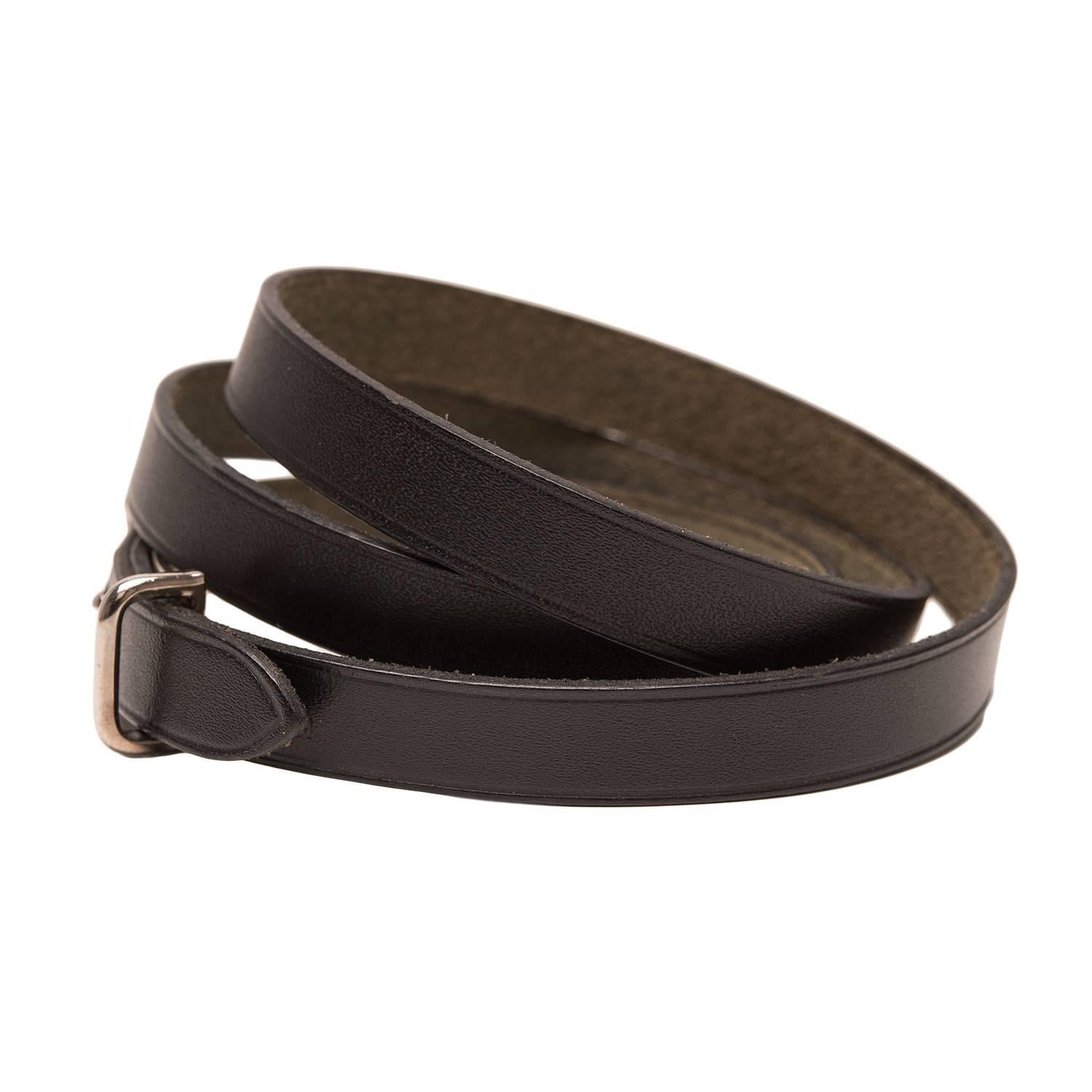 Hermes black calfskin leather quadruple wrap bracelet.

It is with silver and palladium plated hardware.

Origin: France

Condition: Preowned; mint

Accompanied by: Hermes box

Measurements: Length (total): 28.25in; Width:  .375in