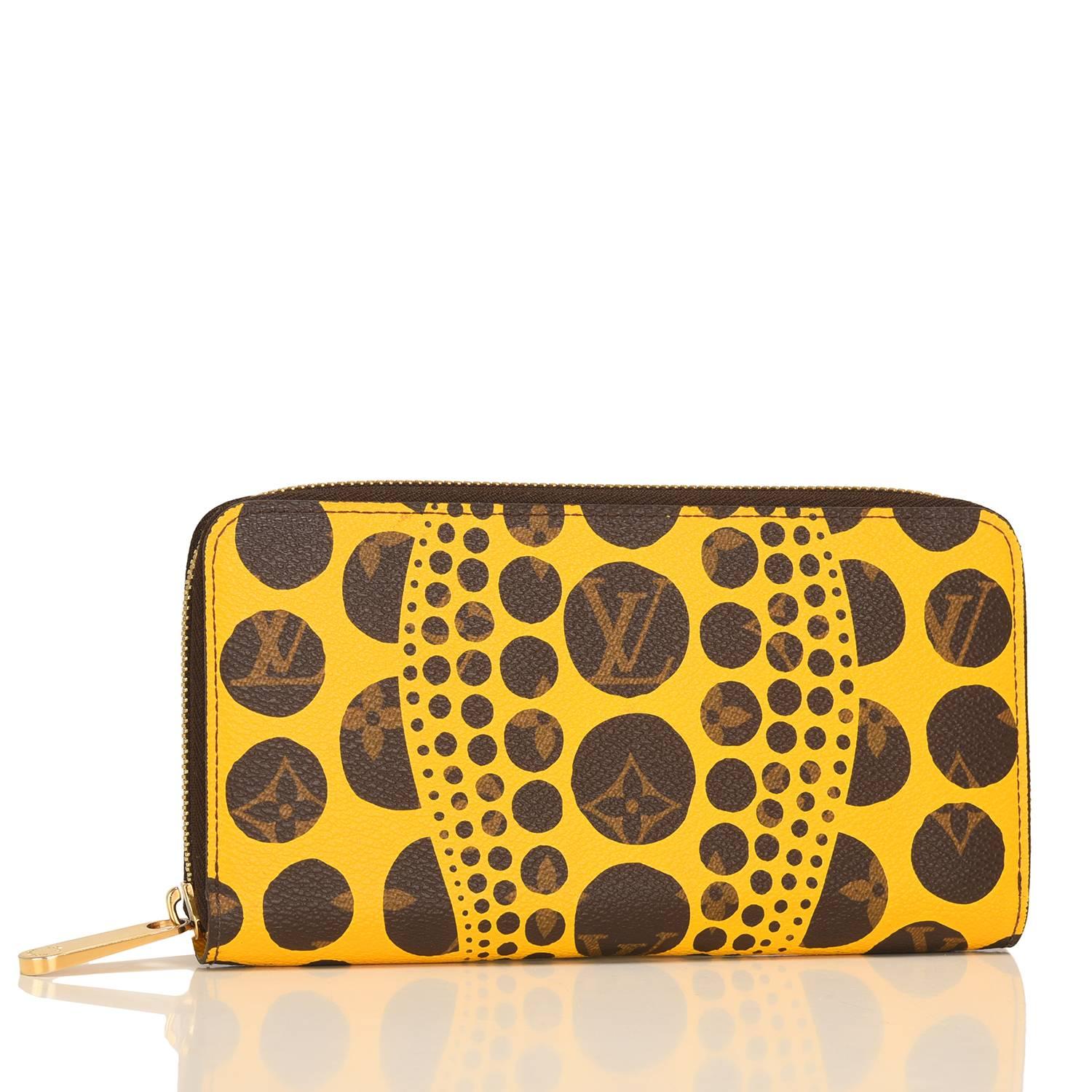 Louis Vuitton Yayoi Kusama Monogram Pumpkin Dots Zippy Wallet of coated canvas and polished brass hardware.

This limited edition wallet has an abstract dots and wave design of yellow silk screened over the classic Monogram design and a 3/4 wrap