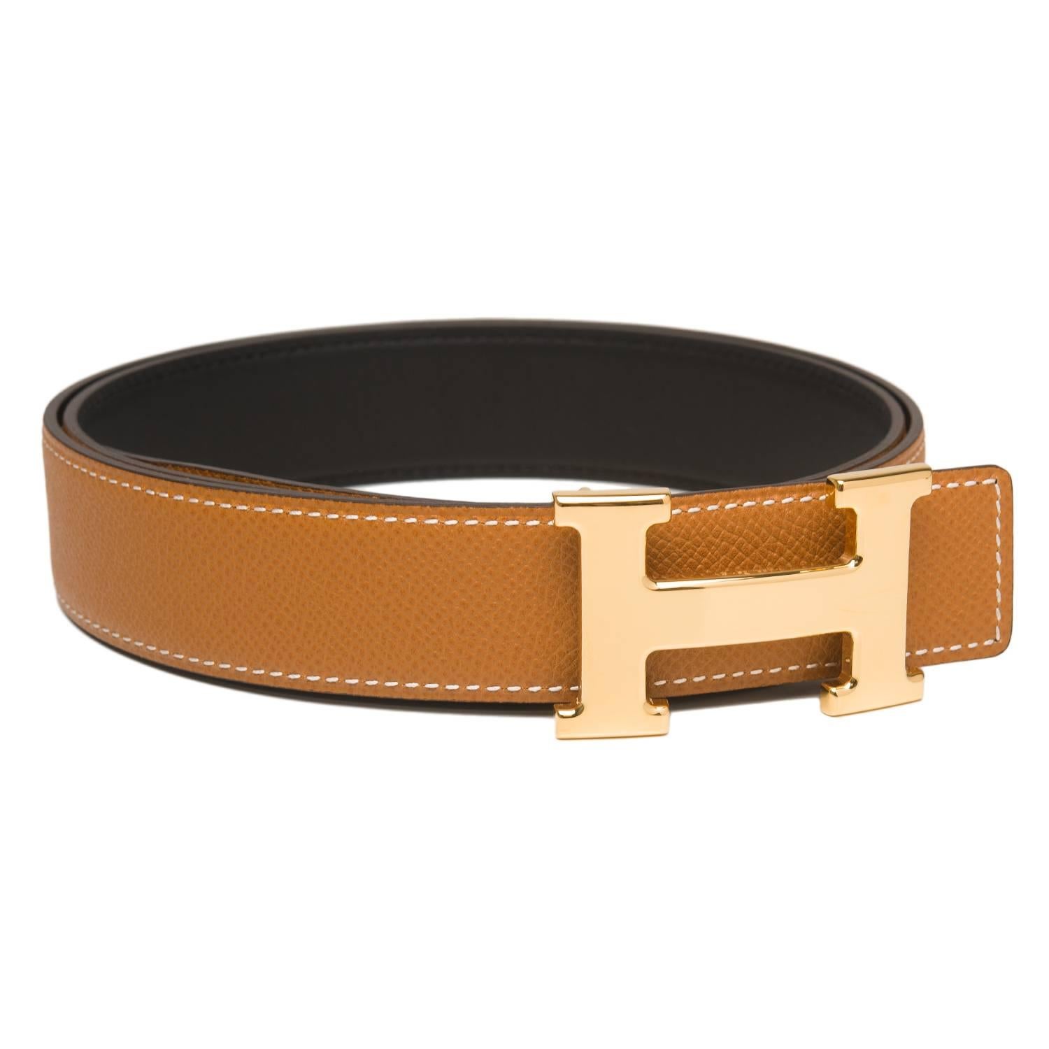 Hermes belt kit comprising an adjustable wide 32mm Constance H belt of black calfskin leather reversing to gold epsom leather with white contrast stitching accompanied by a removable gold plated H buckle.

Origin: France

Condition: Pristine, never