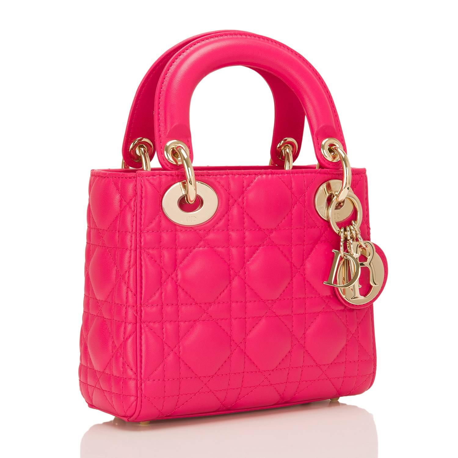 Dior hot pink lambskin Lady Dior Mini bag with permabrass hardware.

This Mini has the iconic cannage pattern all over, gusseted sides, four protective feet at bottom, top flap closure, double rounded flat handles, removable adjustable shoulder