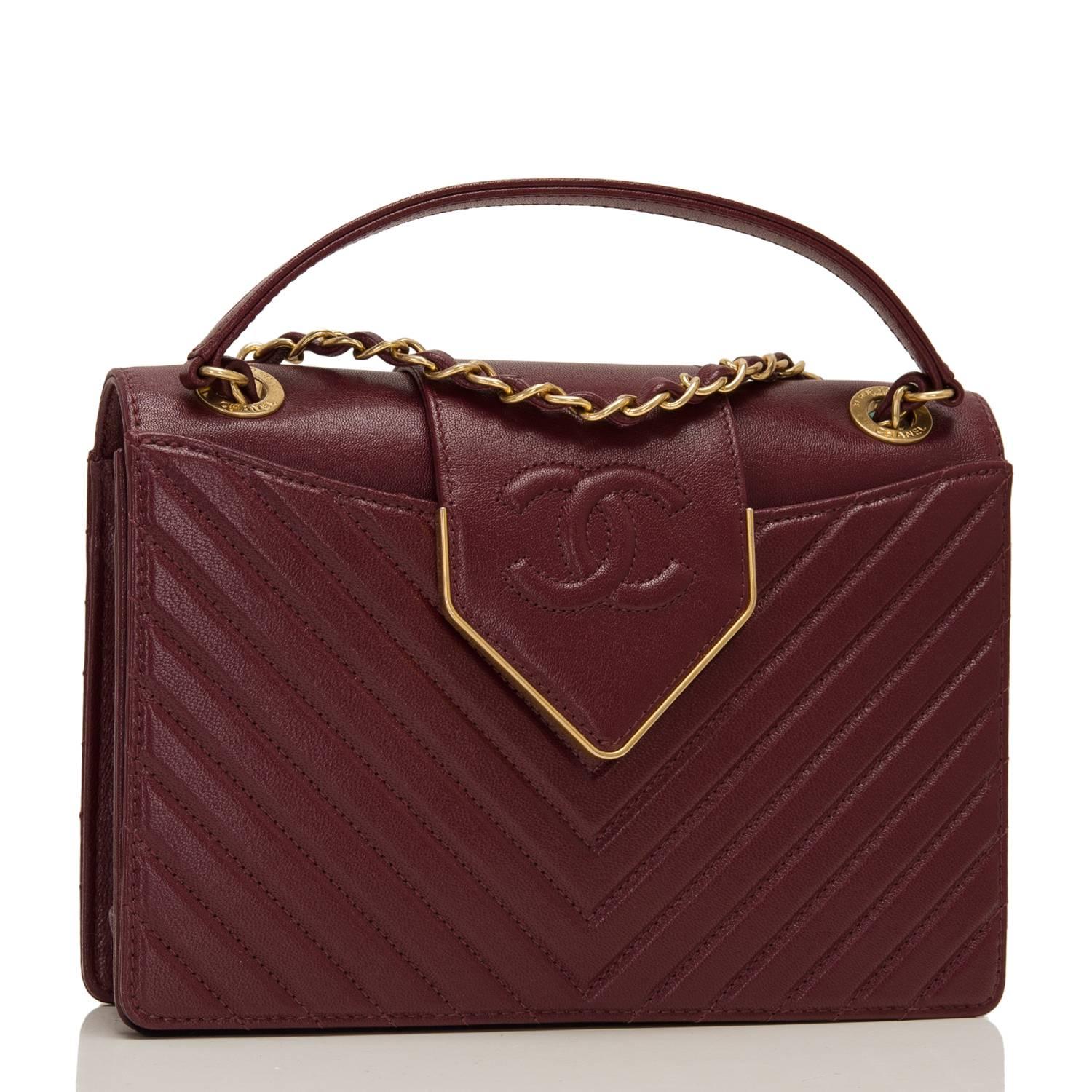 Chanel Paris In Rome burgundy quilted sheepskin flap bag with antique gold tone hardware.

This limited edition bag in a quilted chevron pattern with smooth leather on sides, top and bottom has front and back pockets, a front leather CC and gold