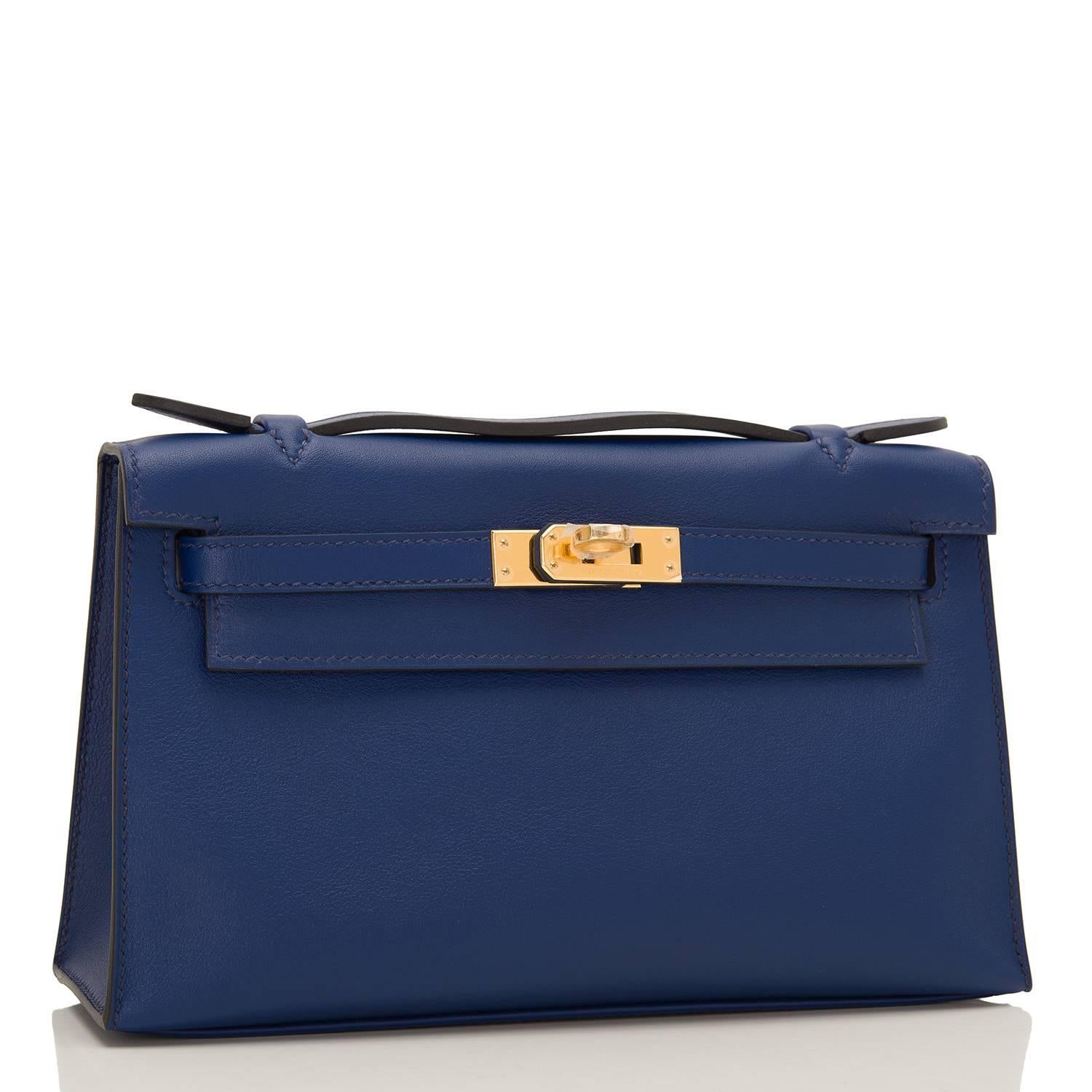 Hermes Blue Sapphire Mini Kelly Pochette of epsom leather with gold hardware.

This Hermes Kelly Pochette has tonal stitching, a front flap with two straps, a toggle closure and a single flat handle.

The interior is lined with Blue Sapphire