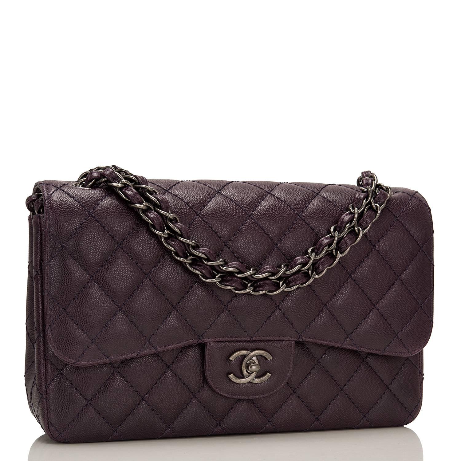 Chanel Jumbo Classic Double flap bag of dark purple quilted caviar leather and accented with aged ruthenium hardware.

The bag features a front flap with signature CC turnlock closure, a half moon back pocket, and an adjustable interwoven aged