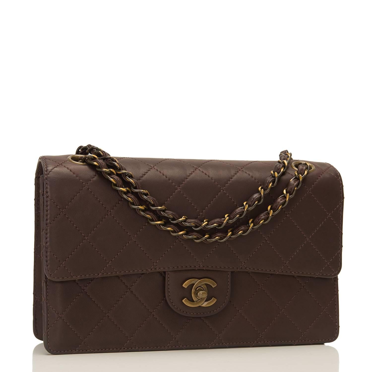 Chanel limited edition single flap bag of dark brown lambskin leather with dark gold "enameled" hardware.

This bag in the classic Medium size features a front flap with dark gold signature CC turnlock closure, tonal stitching, a half
