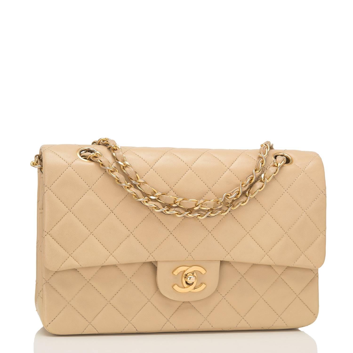Chanel vintage medium Classic double flap bag of beige quilted lambskin accented with 24k gold plated hardware.

The bag features a front flap with signature CC turnlock closure, a half moon back pocket and an adjustable interwoven gold tone