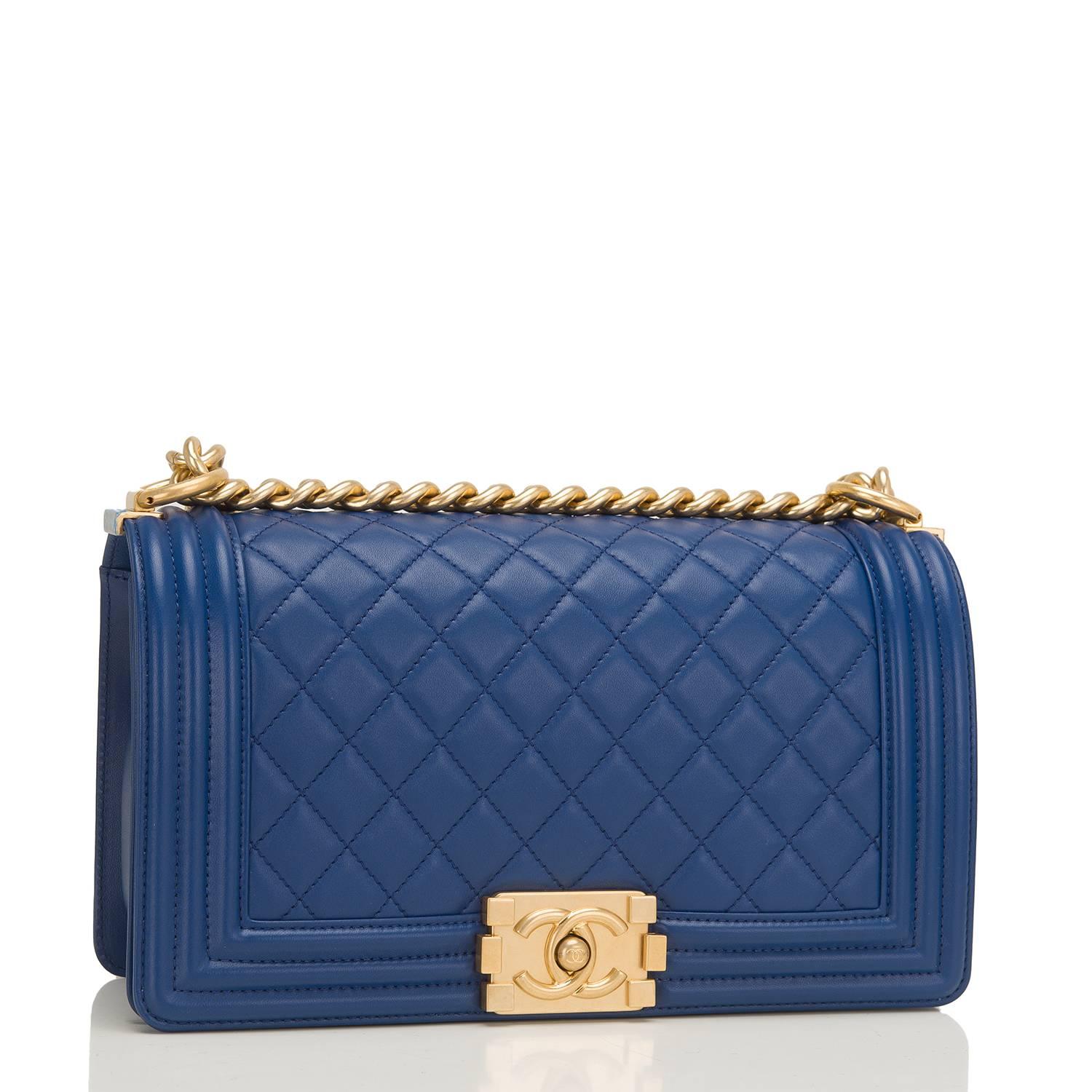 Chanel Old Medium Boy bag of dark blue quilted lambskin and gold hardware.

This Chanel bag is in the classic Boy style with a full front flap with the Boy signature CC push lock closure detail and gold chain link and dark blue leather padded