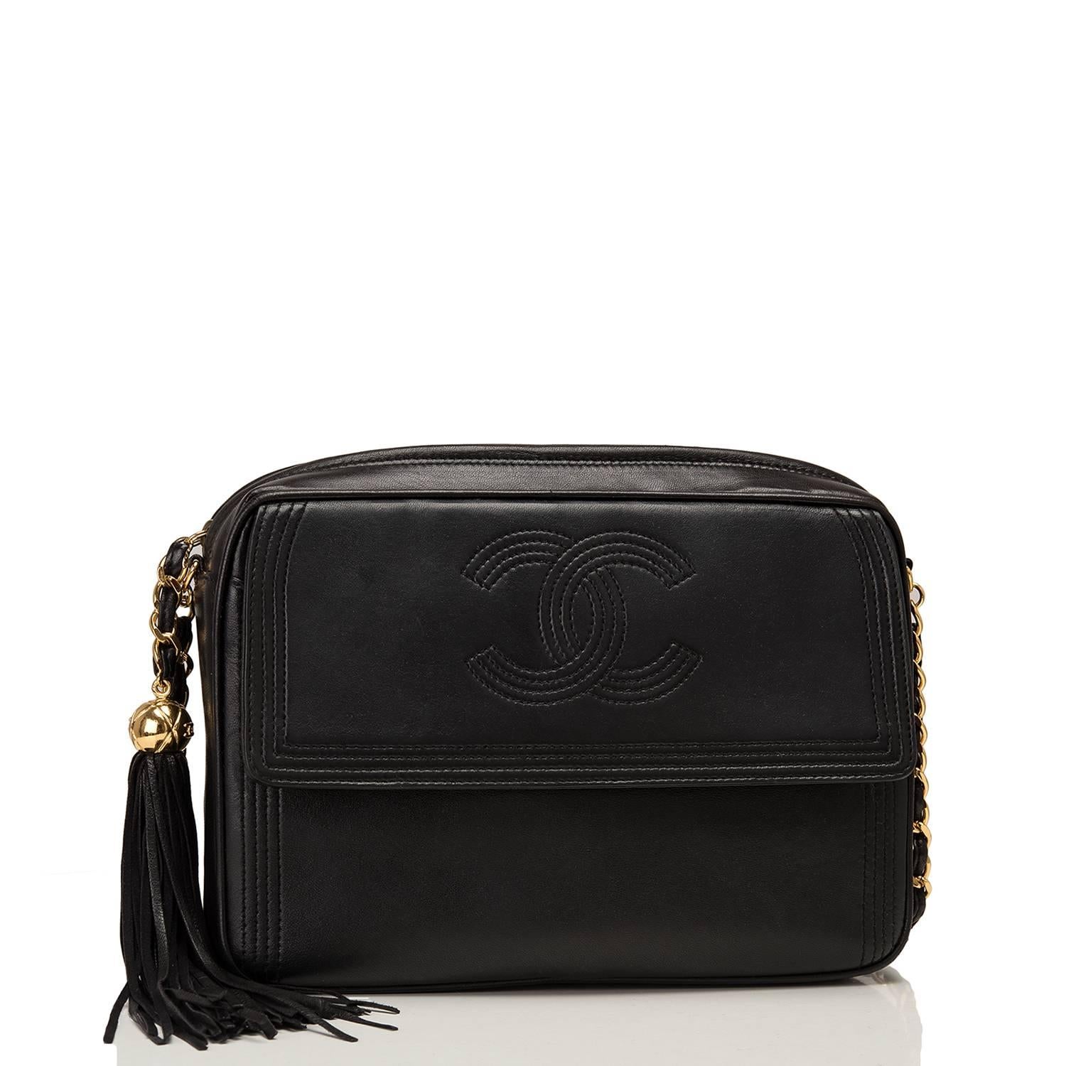 Chanel vintage camera bag of black lambskin leather with gold tone hardware.

This bag features a single pocket at front with snap closure with CC-logo, top zip closure with leather tassel and quilted gold tone ball pull and interwoven gold tone