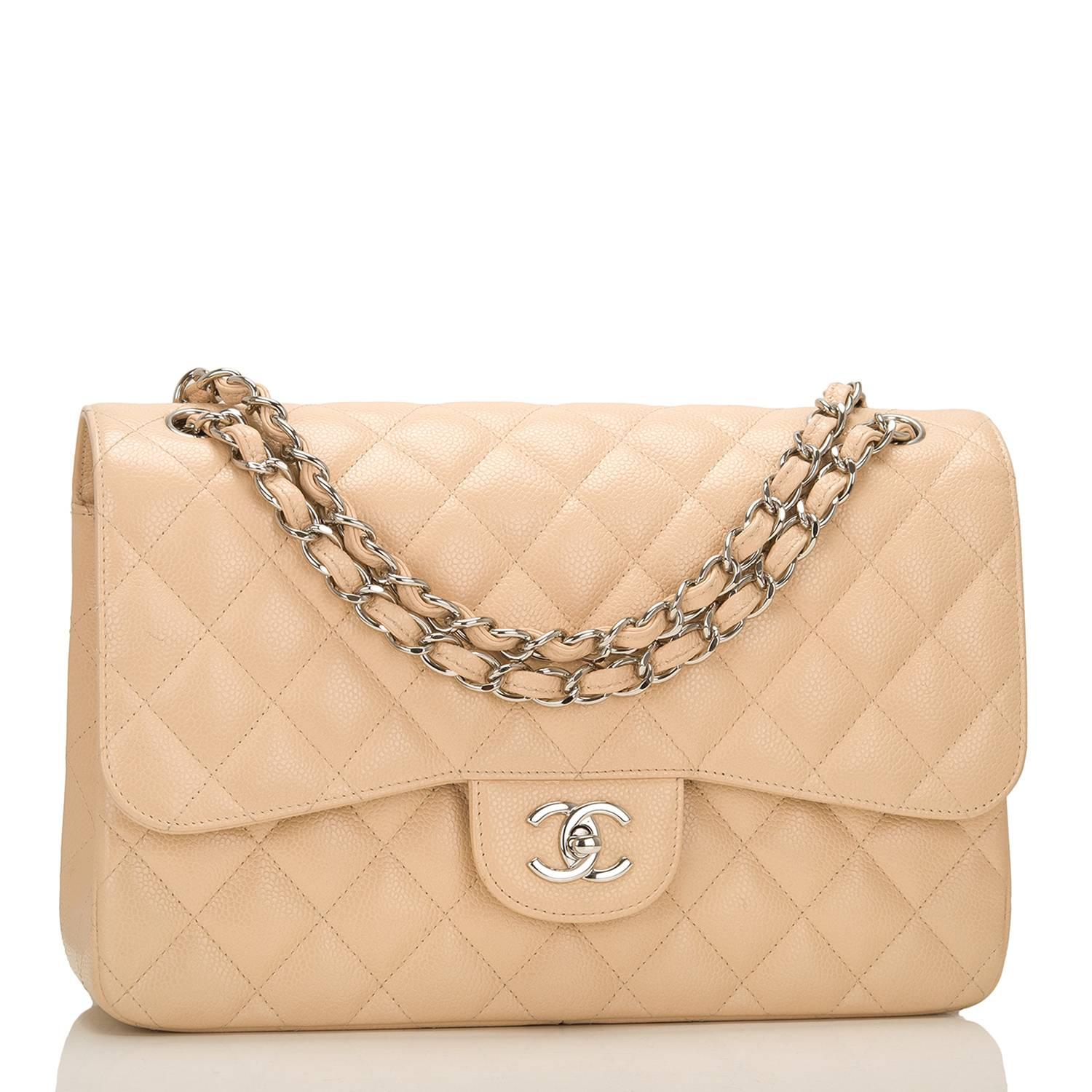 Chanel Jumbo Classic double flap bag of beige quilted caviar leather and accented with silver tone hardware.

The bag features a front flap with signature CC turnlock closure, a half moon back pocket, and an adjustable interwoven silver tone chain