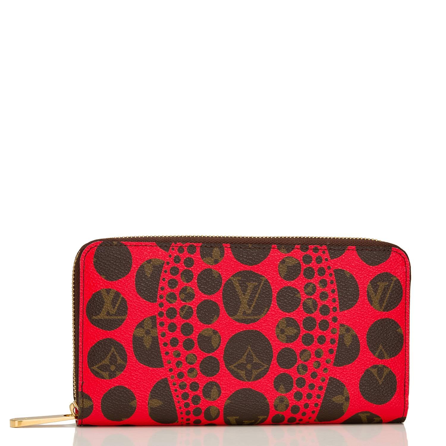 Louis Vuitton Yayoi Kusama Monogram Pumpkin Dots Zippy Wallet of red coated canvas and polished brass hardware.

This limited edition wallet has an abstract dots and wave design of red silk screened over the classic Monogram design and a 3/4 wrap
