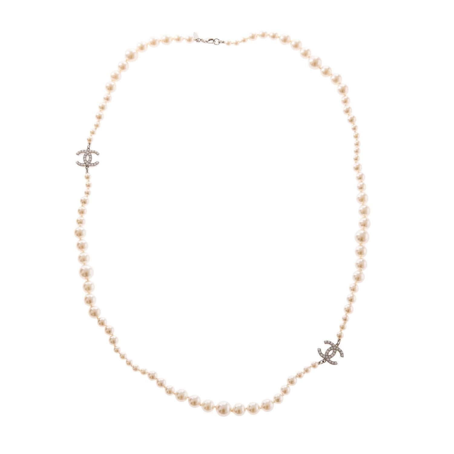 Chanel necklace of graduated faux pearls and two silver tone and pearl embedded charms with lobster claw closure.

Collection: Stamped 09V (for 2009)

Condition: Mint; all pearls intact; hardware is bright and shiny with no visible scratches;