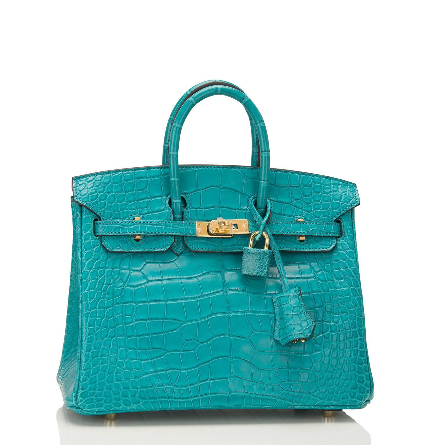 Hermes Blue Paon Birkin 25cm in matte alligator with gold hardware.

This Birkin has tonal stitching, a front toggle closure, a clochette with lock and two keys, and double rolled handles.

The interior is lined with Blue Paon chevre and has one