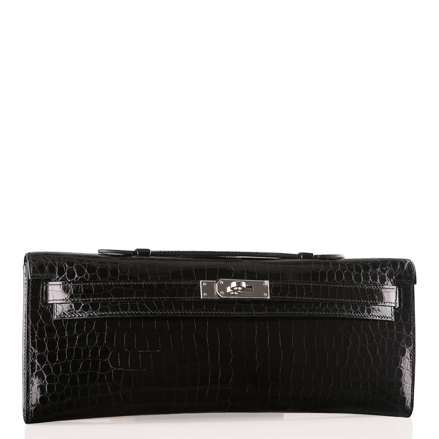 Hermes Black Kelly Cut of shiny porosus crocodile with palladium hardware.

This exotic Kelly Cut has tonal stitching, front straps with a toggle closure and a top flat handle.

The interior is lined with Black chevre leather and has an open