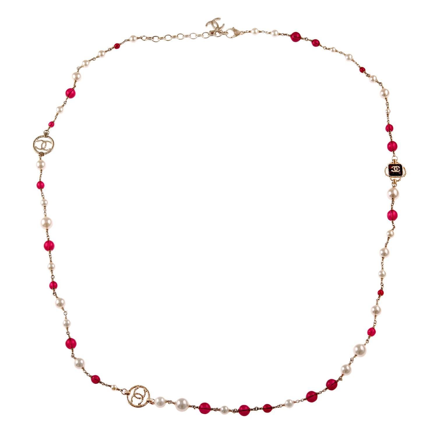 Chanel limited edition matte gold tone sautoir necklace of matte gold tone metal, faux pearls and pinkish red resin beads.

This necklace has alternating glass ivory pearls, and red resin pearls with Florentine finished matte gold braided CC-logo