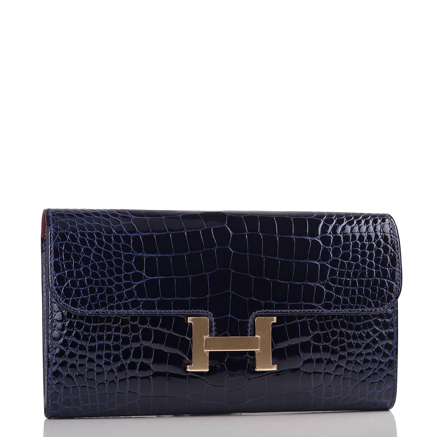 Hermes Constance Long Clutch of Blue Marine alligator leather with rose gold hardware.

This clutch, which can also be worn as a wallet, has tonal stitching, a metal 