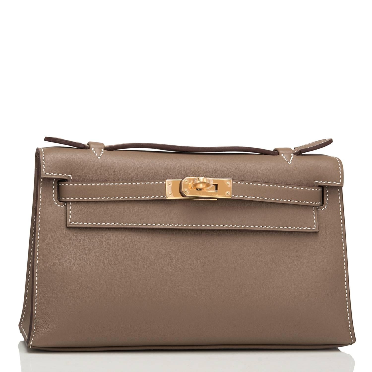 Hermes Etoupe Mini Kelly Pochette of swift leather with gold hardware.

This Hermes pochette has contrast stitching, a front flap with two straps, a toggle closure and a single flat handle.

The interior is lined with etoupe chevre and has one