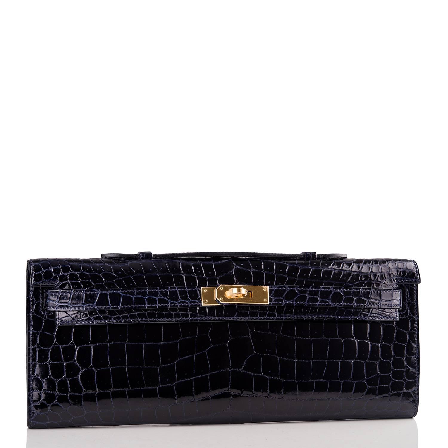 Hermes Blue Marine Kelly Cut of shiny porosus crocodile with gold hardware.

This exotic Kelly Cut has tonal stitching, front straps with a toggle closure and a top flat handle.

The interior is lined with Blue Marine chevre leather and has an open