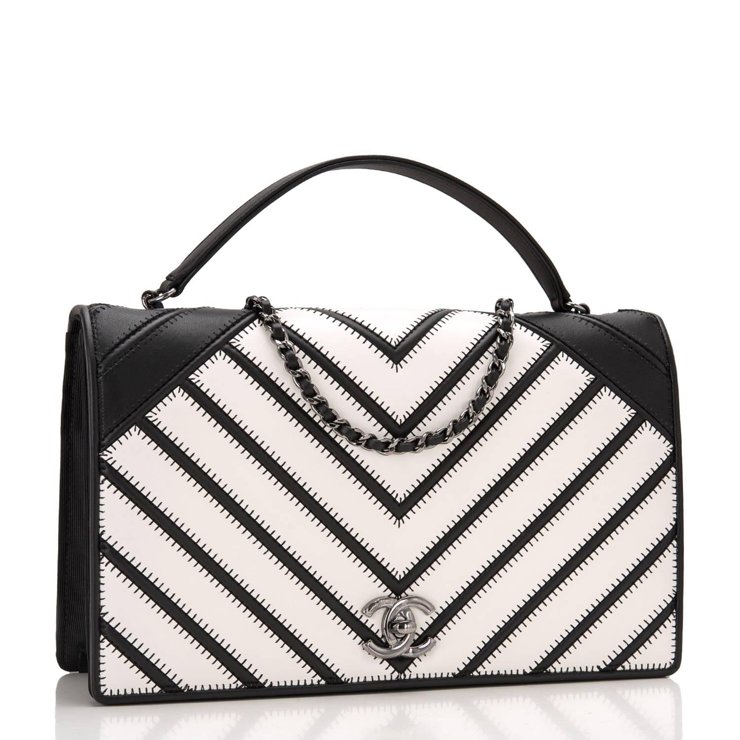 Chanel Chevron Couture Flap Bag of black and white chevron lambskin, black fabric and ruthenium hardware.

This limited edition runway bag features a full front flap with CC turnlock closure, black and white leather front and back, black fabric