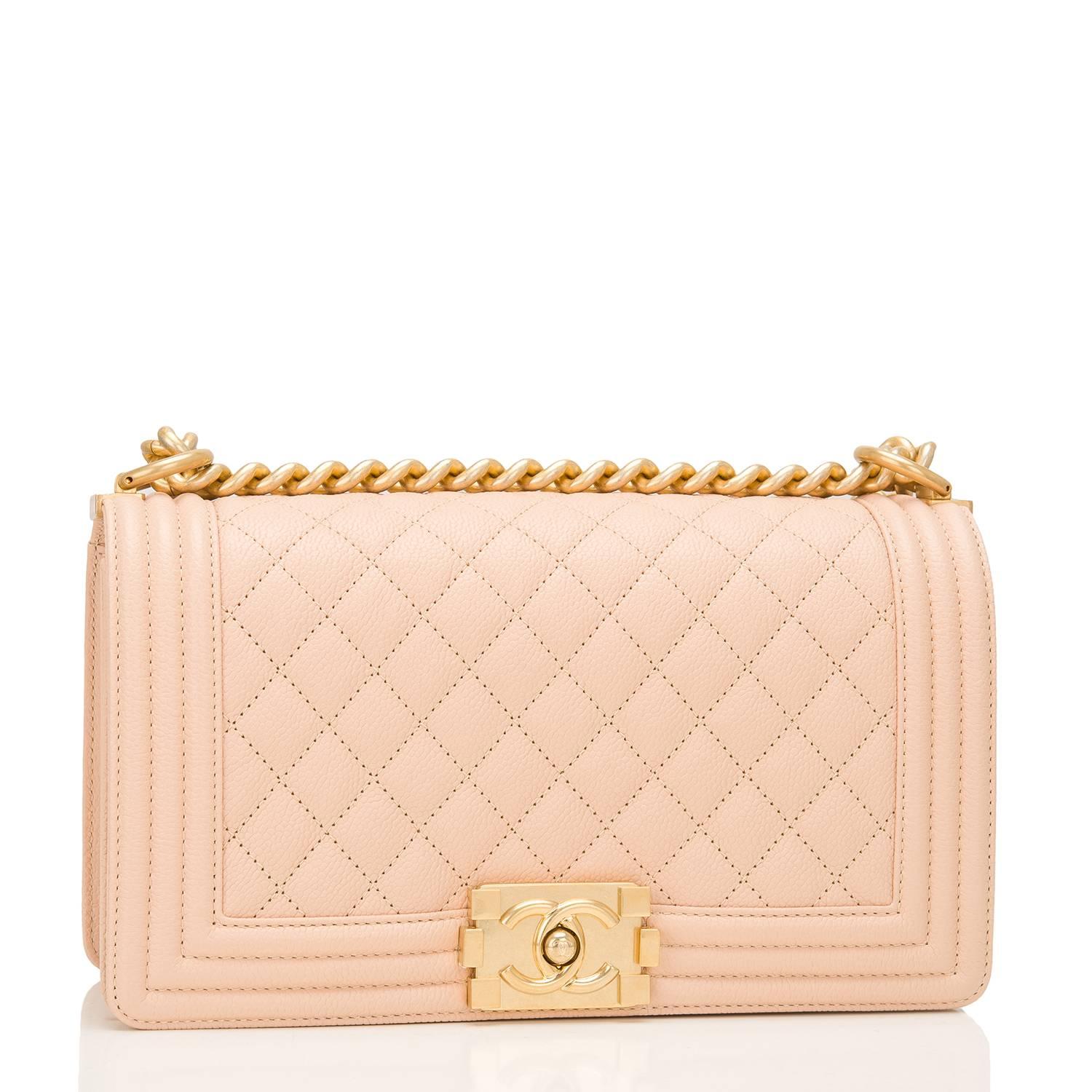 Chanel Old Medium Boy bag of light beige quilted caviar leather and antique gold hardware.

This Chanel bag is in the classic Boy style with a full front flap with the Boy signature CC push lock closure, smooth leather trim and antique gold chain