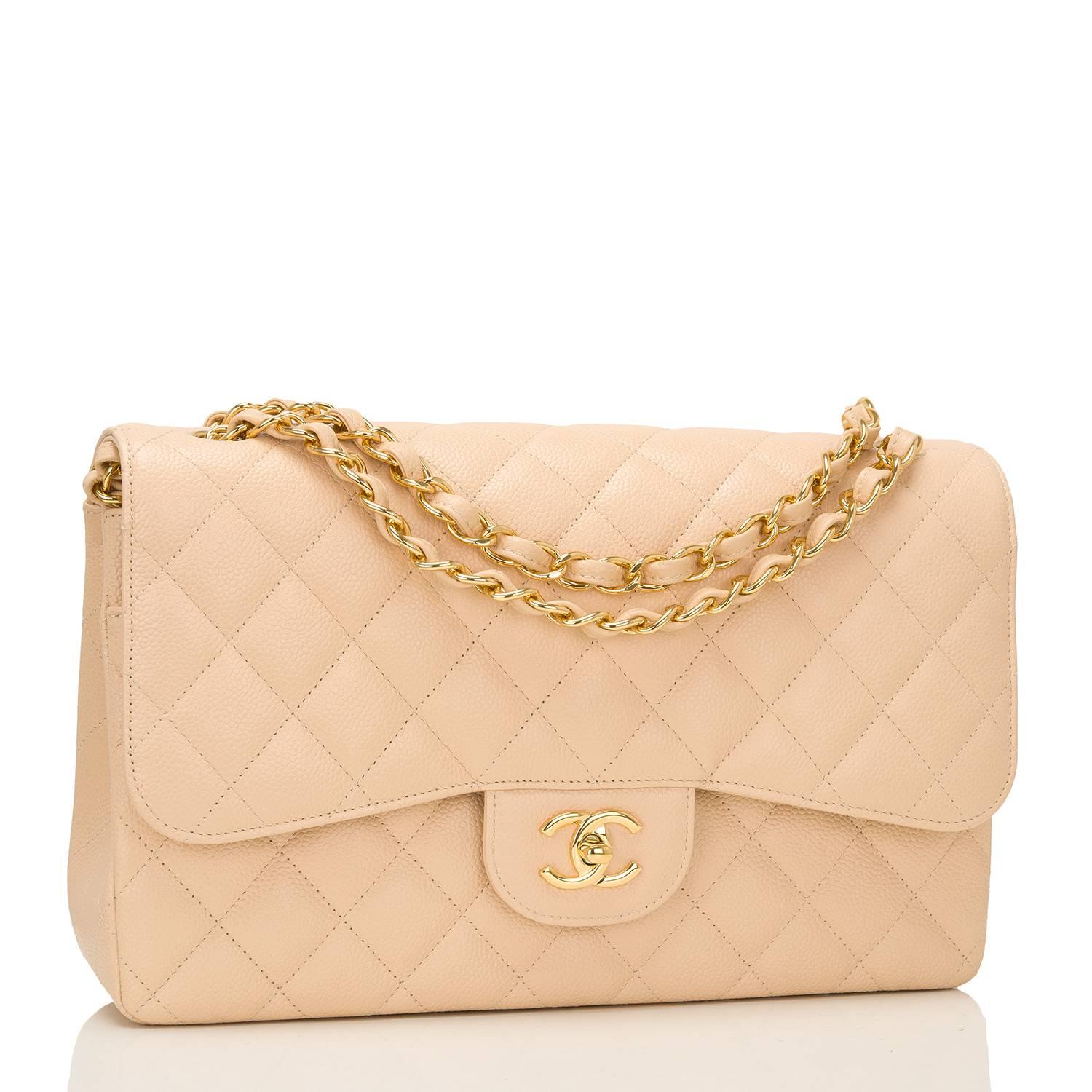 Chanel Jumbo Classic double flap bag of beige quilted caviar leather and accented with gold tone hardware.

The bag features a front flap with signature CC turnlock closure, a half moon back pocket, and an adjustable interwoven gold tone chain
